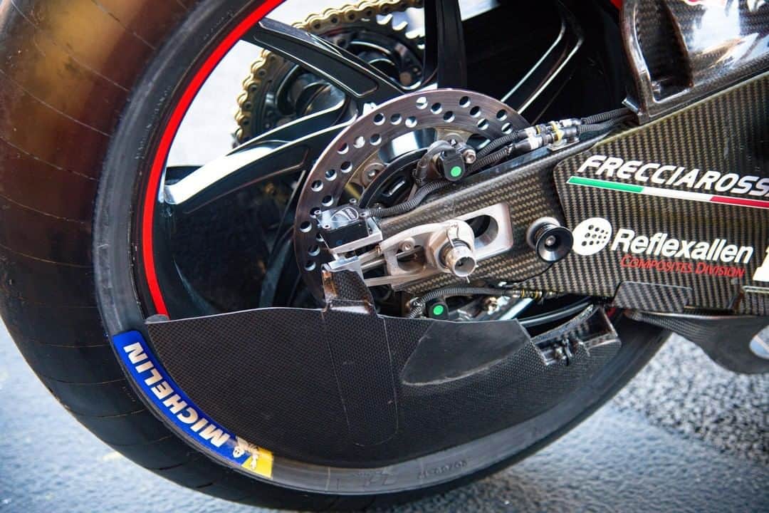 MotoGPさんのインスタグラム写真 - (MotoGPInstagram)「#MotoGPInParts - Rear Wheel Aero. Wheel covers are something we've looked at before but not on the rear wheel. Ducati continued their innovations last year when they rolled out this rear wheel aero cover not long after unveiling the one for the front wheel.  The idea behind the rear wheel aero is much the same as for the front. When a wheel rotates it creates turbulent air, making it the least aerodynamic part of the motorcycle. Covering it reduces some of the turbulence, stopping air from spilling out the sides of the wheel and allowing air from the front of the bike to pass down the side of the bike much easier and with less interruption.  The result of this is that the bike becomes more aerodynamic. The air can follow a smoother path rather than encountering turbulent air and disrupting the flow. One thing that was said at the start of 2019 when wheel covers were first seen was that as they allow air to pass by the wheel much closer, and in a more uniformed style, they might cause some degree of cooling to the tyre. The theory goes that as the air passes by the tyre it could help with taking heat away from the surface of the tyre, but it's unknown whether it actually does this or not  In summary, rear wheel covers are, first and foremost, for reducing turbulence and achieving higher aerodynamic efficiency. If you like these types of posts, make sure you check out our 'MotoGP Tech' Facebook group!」6月30日 16時01分 - motogp
