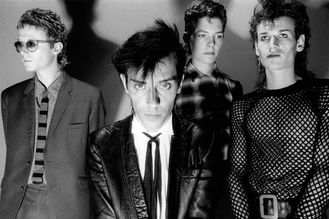 アンダーグラウンドのインスタグラム：「Forming in Northampton, England in 1978, Bauhaus were highly influential in pioneering goth-rock. Inspired by bands such as Siouxsie and the Banshees, Bauhaus were known for their dark persona and gloomy sound. However, this didn’t limit the band from mixing other genres such as power pop, funk and psychedelia. Their debut single ‘Bela Lugosi’s Dead’ (1980), failed to make a dent in the UK Singles Chart. Still, their debut album In the Flat Field (1980) marked the beginning of their commercial success and their experimental glam-rock sound. ⁠ ⁠ Today, we will take a look at these iconic goth bands throughout the decades, and see how the pioneers have permeated the culture and helped shape the sounds of our generation. Read full article on our blog, link in bio.⁠ ⁠ (📸: Fin Costello)⁠ ⁠ #gothrock #gothbands #britishmusic #undergroundengland #bauhaus」