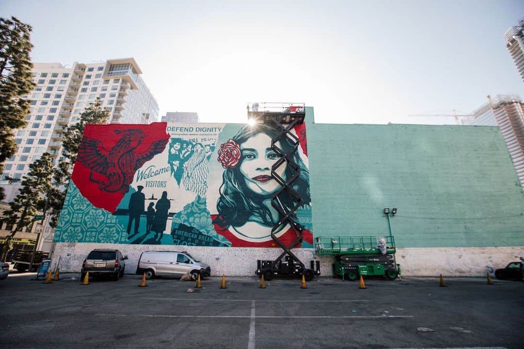 Shepard Faireyさんのインスタグラム写真 - (Shepard FaireyInstagram)「Today, I'm throwing it back to one of my largest murals in LA, which I completed last November, in partnership with @brandedarts, @oti.official and my mural crew. This "Defend Dignity" piece was created to inspire sensitivity toward our fellow human beings and the planet itself. The central image, one of three that I created for the WE THE PEOPLE series, is a portrait of Maribel Valdez Gonzalez, a Texan of Mexican descent who was photographed by @ari.mejorado. I collaborated with Arlene, who works on immigrants' rights, to create this image as a symbol of hope, dignity, and humanity. The bleeding lotus is a symbol of the beauty and fragility of our planet. ⠀⠀⠀⠀⠀⠀⠀⠀⠀⁣⁠⠀ One of the most significant ways we can defend dignity and protect humanity in this country is to make our voices heard and VOTE this upcoming November. I created MAKE AMERICA SMART AGAIN with my wife, @amandafairey in 2016 as a call to action for Americans to be more involved in our democracy. Stay informed and follow us on @dumbisovermasa! As always, thanks for caring.⁠⠀ -Shepard⁠⠀ ⠀⠀⠀⠀⠀⠀⠀⠀⠀⁣⁠⠀ 📷: @jonathanfurlong #throwback #tbt #obey #obeygiant #shepardfairey」7月3日 2時01分 - obeygiant