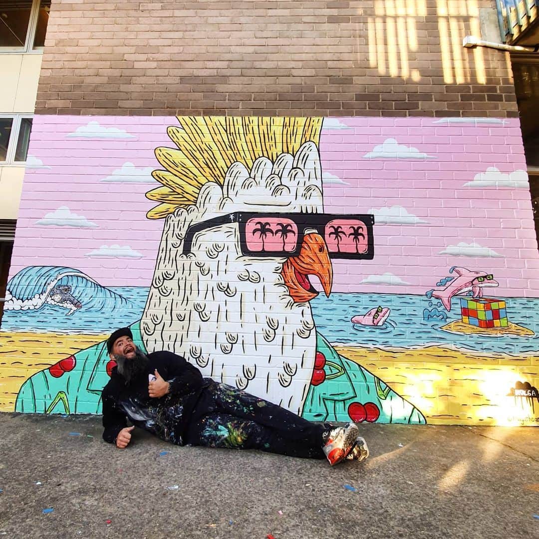 MULGAさんのインスタグラム写真 - (MULGAInstagram)「Cherry the Chiller Cockie mural at @southsydneyhsofficial. ⁣ ⁣ Thanks @tint.paint for the colours and Rob and the crew at school for having me down for a paint and helping me paint.⁣ ⁣ The story of Cherry the Chiller Cockie⁣ ⁣ Once there was a Cockatoo called Cherry the Chiller Cockie because cherries were his favourite food and he was a mad chiller. He loved wearing his cherry themed Hawaiian style shirts and he had 7 cherry themed shirts for everyday of the week and if you ever bumped into him down at Maroubra Beach you were guaranteed to catch him chilling whilst wearing a cherry themed Hawaiian style shirt and maybe nibbling on a Cherry Ripe chocolate bar. Sometimes he went surfing in his cherry themed Hawaiian style shirt, adding much colour and flair to the line up. That's the story of Cherry the Chiller Cockie.⁣ ⁣ The End⁣ ⁣ #mulgatheartist #muralart #schoolmural #sydneystreetart #cockatoo #cockatooart #australianart #rubixcube #maroubrabeach」7月7日 12時04分 - mulgatheartist