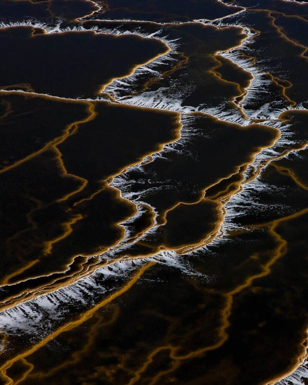 ナショナルジオグラフィックさんのインスタグラム写真 - (ナショナルジオグラフィックInstagram)「Photo by George Steinmetz @geosteinmetz  The level of the Dead Sea is dropping by about three feet (one meter) per year, due to freshwater diversions for human use. The lowest point on Earth is now separated into two depressions. The southern lobe has been converted into evaporation ponds for industrial use. On the Israeli side, shown here, that includes coffee-colored cascades of brine to concentrate and extract products ranging from potash for fertilizer to flame retardants to batteries. To view more of our world from above, follow @geosteinmetz.」7月8日 3時37分 - natgeo