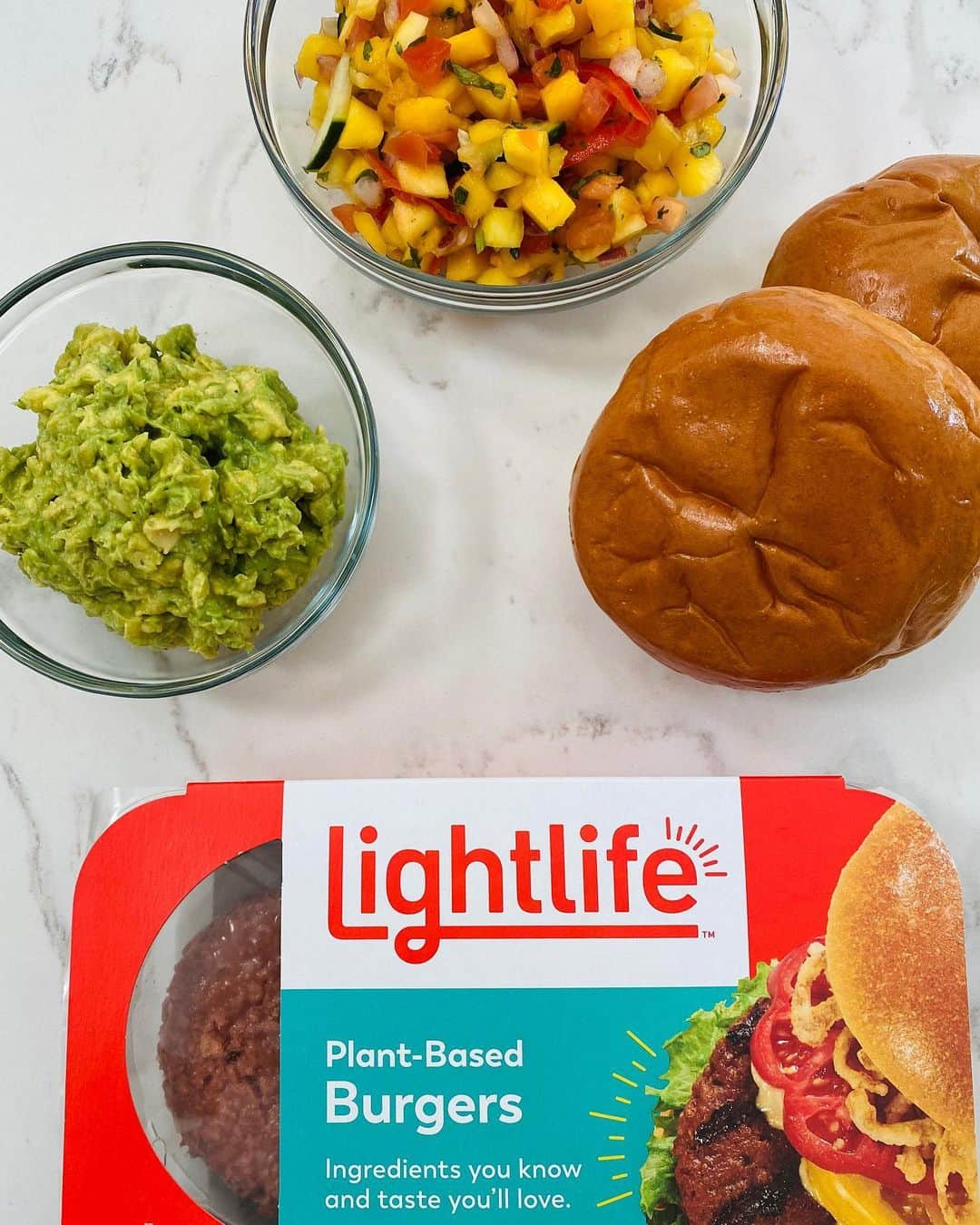 Gaby Dalkinさんのインスタグラム写真 - (Gaby DalkinInstagram)「Prepped and ready for an avocado / mango salsa plant-based burger kinda night #ad The new and improved @lightlifefoods Plant-Based Burgers (which we currently have fully stocked in the freezer) are exactly what the doctor ordered for a hot summer night!  They’re made with simple ingredients,  and they’re totally deliciously -  a dream burger! If you haven’t had them yet - get on it and get cooking! #Lightlife   Mango Salsa  1 ripe mango peeled, seeded, diced 2 tbsp finely chopped red onion 2 tbsp chopped cucumber 2-3 tbsp fresh lime juice 1 jalapeño, minced  Guac 2 ripe avocados 2 tbsp finely chopped red onion 3 tablespoons freshly chopped chives 1/2 lemon juiced 1/2 lime juiced 2 teaspoons finely chopped jalapeño Kosher salt and freshly cracked black pepper to taste  Burgers 1 package Lightlife Plant-Based Burgers Brioche Buns   Cook the Lightlife Plant-Based Burgers on a grill according to the package directions. Remove and toast the buns until lightly golden.  Mango Salsa  Combine the diced mango, onion, cucumber, lime juice and jalapeño in a medium bowl. Toss to combine and season with salt and pepper.  Guac Cut the avocados in half lengthwise. Remove the pit from the avocado and discard. Remove the avocado from the skin and place the avocado flesh into a bowl. Add the lemon juice, lime juice, red onion, chives, jalapeño, salt and pepper. Mash with a fork until half smooth and creamy. Taste and add more salt and pepper if desired. Serve everything together and enjoy!」7月10日 10時02分 - whatsgabycookin