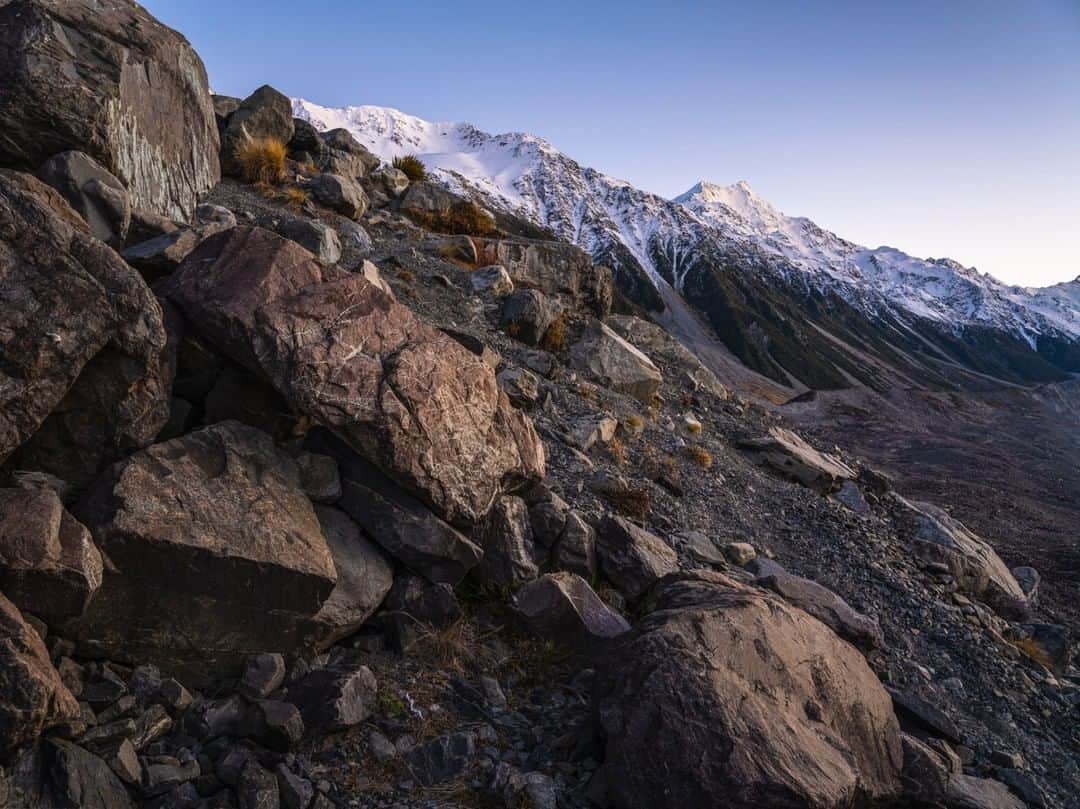 National Geographic Travelさんのインスタグラム写真 - (National Geographic TravelInstagram)「Photo by @michaelclarkphoto  Mount Cook (also known as Aoraki), seen here from the Tasman Glacier, is the tallest peak in the southern alps of New Zealand. At 3,724 meters (12,218 feet) and with three separate summits, it is a serious challenge for any mountaineer. On this morning I woke up long before sunrise to drive out to the toe of the Tasman Glacier and find various locations to capture the sunrise. I was all alone, possibly because it was late fall and quite cold. Over the last few months while in lockdown due to COVID-19, I have been able to go back and work up some of these images I captured last year in New Zealand. It has been a great form of escape. One of these days I would love to go back! #newzealand #mtcook #aoraki #tasmanglacier」7月11日 21時07分 - natgeotravel