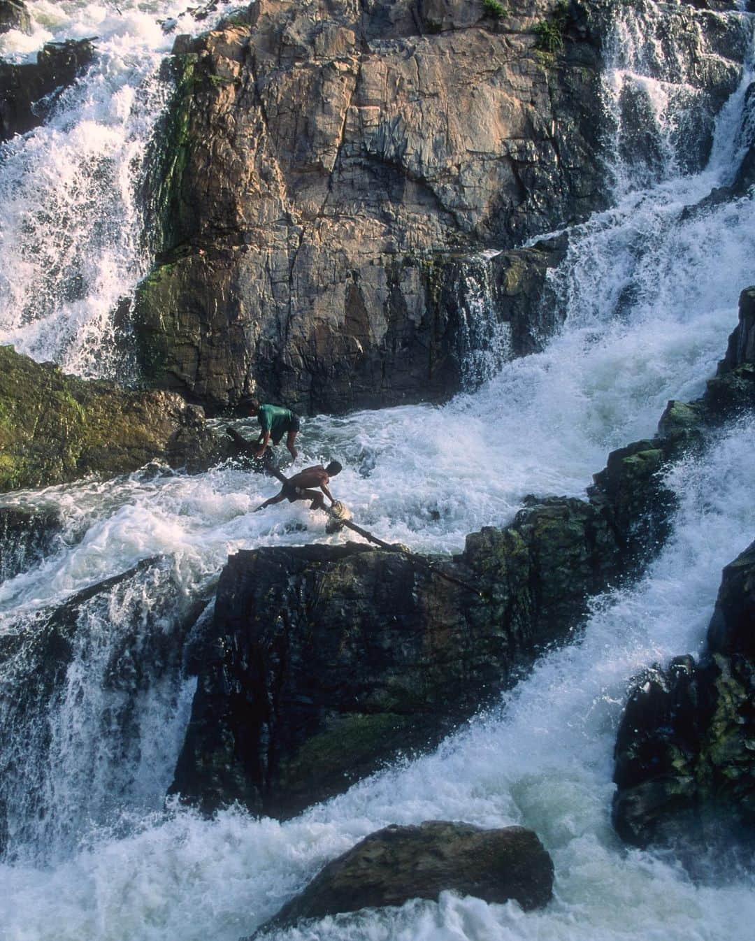 Michael Yamashitaさんのインスタグラム写真 - (Michael YamashitaInstagram)「The Mekong comes crashing out of Laos through 6 miles of cataracts known as Khone Falls — the barrier that dashed the hopes of French Explorers searching for an inland trade route to China. The Khone Falls are the largest in Southeast Asia,  and at 35,376 feet (10,783 m) wide, it is the widest waterfall in theworld. The Khone has the greatest volume of the world’s waterfalls, its 2,500,000 gallons (9,500,000 litres) per second being nearly double that of Niagara Falls. Here, 2 fishermen confront the raging rapids throwing their nets to catch fish headed for spawning grounds upstream. #khone #khonefalls #laos #cambodia #mekong #mekongriver #fishing #fishermen   From the book “Mekong: A Journey on the Mother of Waters”. A limited number of  signed copies of this out of print book are available to purchase from our website michaelyamashita.com or the link in our profile」7月13日 9時39分 - yamashitaphoto