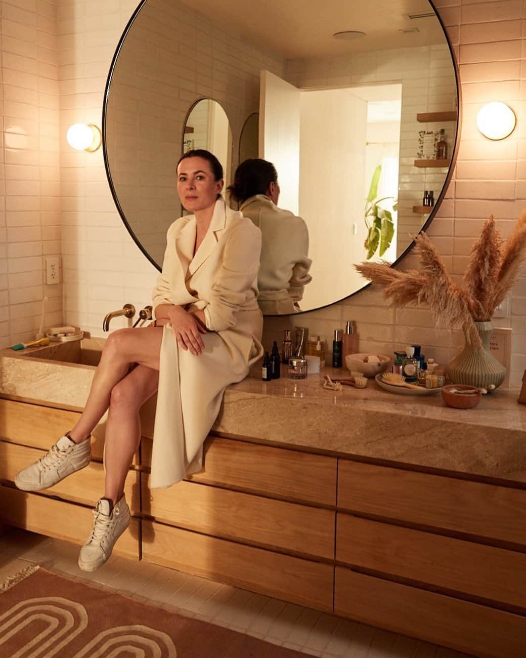 ギャランス・ドレのインスタグラム：「Love this photo in my messy bathroom in the sunset light ... It was an absolute joy to work with @colienarentmeester and all the @vogueliving_nl team - I often dread having my photo taken (I learned to get good at pausing so that it would go faster ahah!) but sometimes it’s just natural and easy and me.  . Happy weekend!  @sarahshermansamuel 💛💛💛」