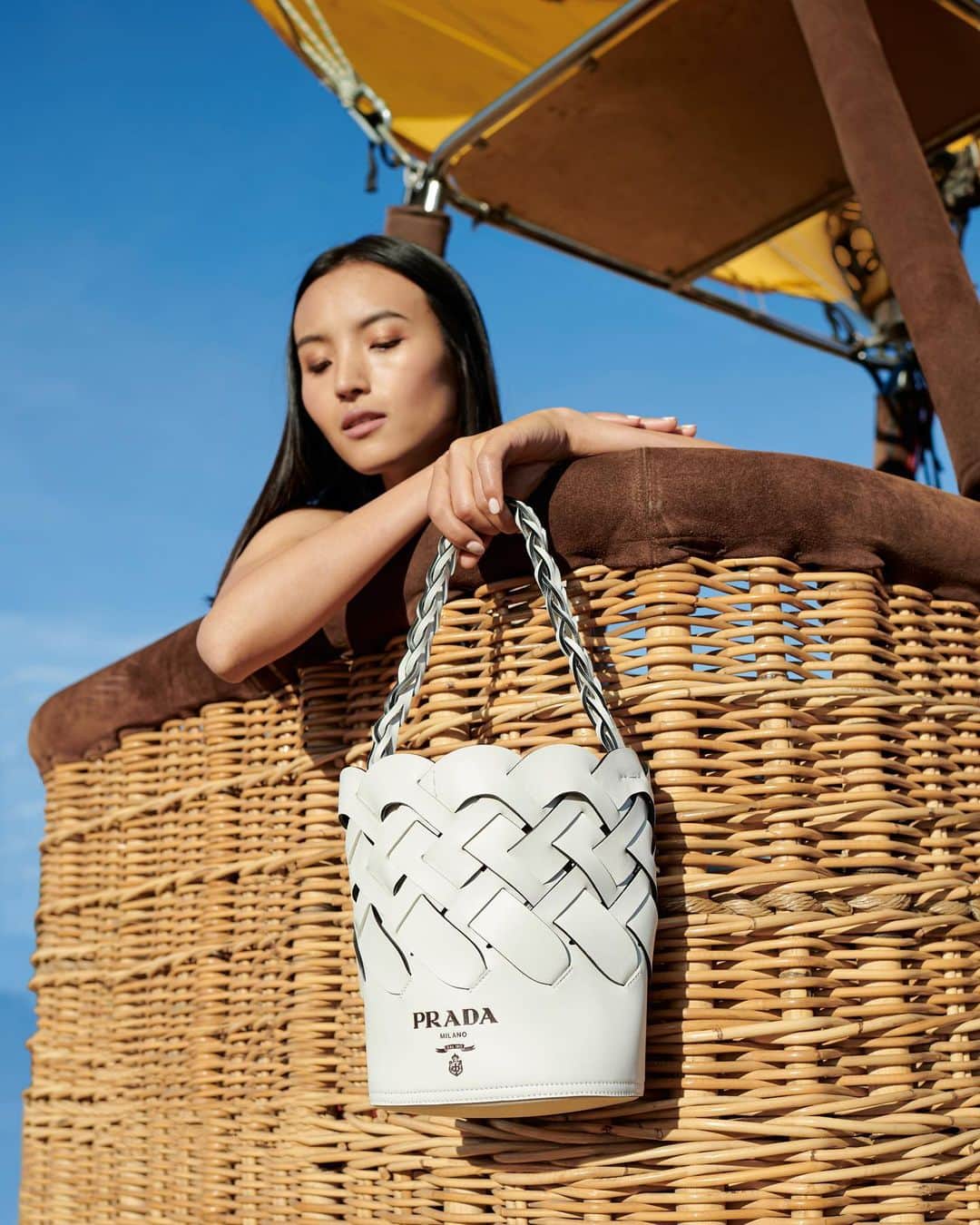 のインスタグラム：「The basket-weave motif has gone through a major style evolution, from hot air balloons to this @prada bucket bag.」