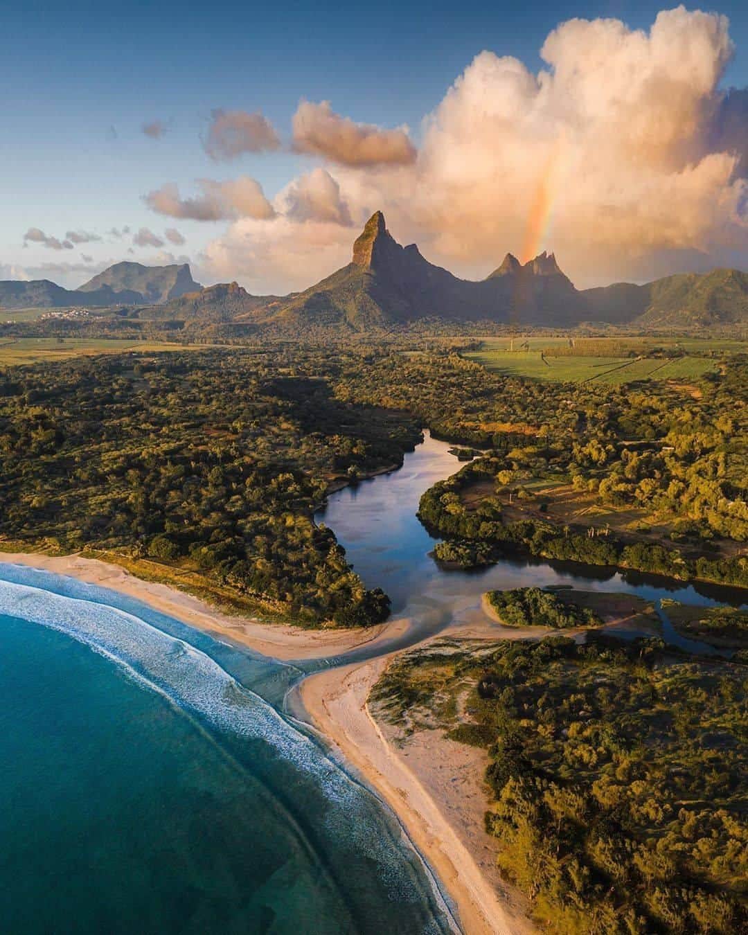 Discover Earthさんのインスタグラム写真 - (Discover EarthInstagram)「"Sunset walks along the beach... Underneath “The Matterhorn of Mauritius.” 🌅⠀⠀⠀⠀⠀ The mountain isn’t actually called this but my Mauritian friends called it that and I like the nickname 😂 Who wants to hop in one of those boats (2nd picture) and go take a closer look at this epic mountain? 🚤" Photos by @braybraywoowoo 🇲🇺 #discovermauritius   #mountain #mauritius #matterhorn」7月19日 0時00分 - discoverearth