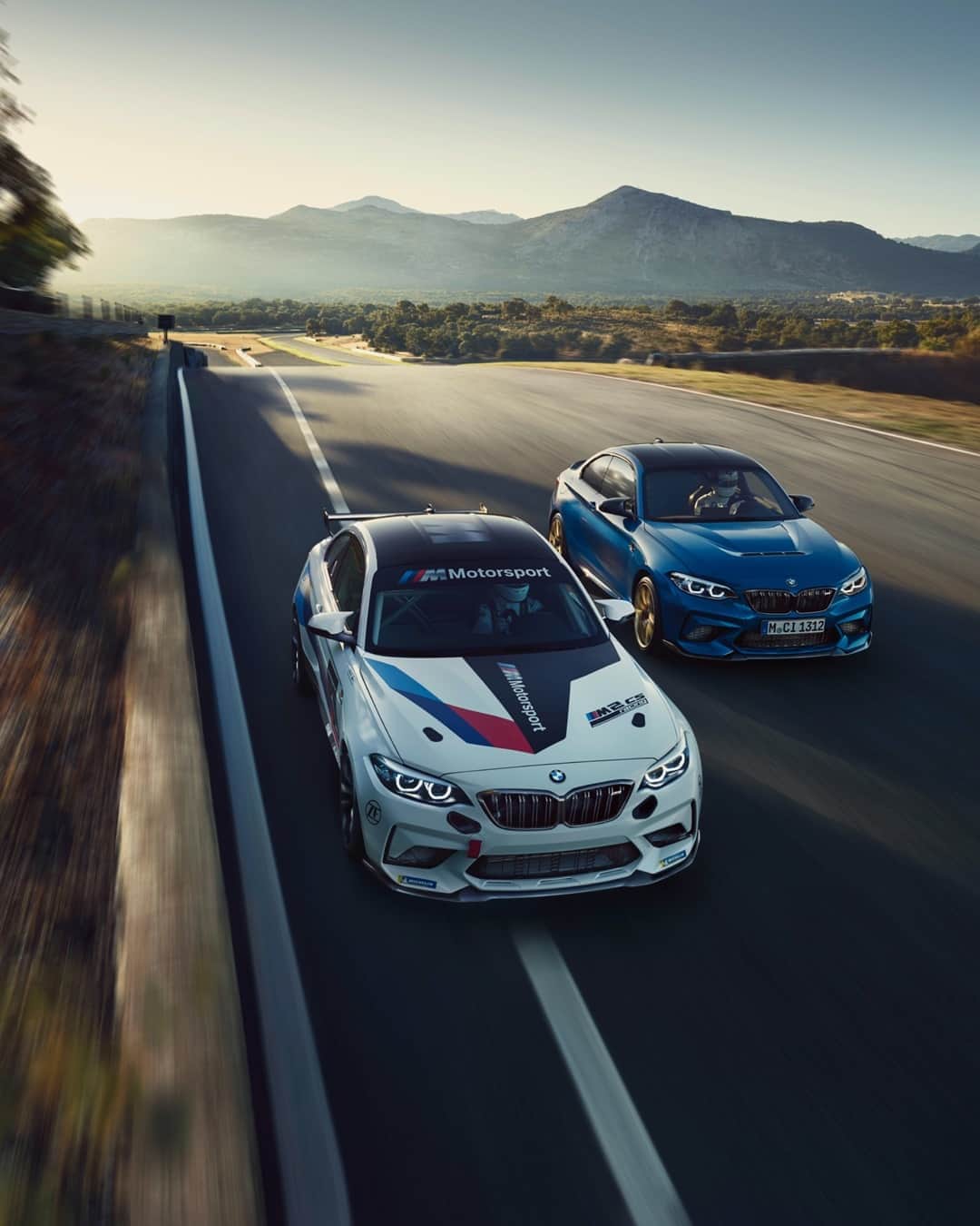 BMWのインスタグラム：「Strength and dynamism head to head. The BMW M2 CS and BMW M2 CS Racing. #TheM2 #BMWM #BMW #M2 @BMWM  __ BMW M2 CS: Fuel consumption in l/100 km (combined): 10.4–10.2 [9.6–9.4]. CO2 emissions in g/km (combined): 238–233 [219–214]. Further information: www.bmw.com/disclaimer.  	 Acceleration (0-100 km/h): 4.2 s [4.0 s]. Power: 331 kW, 450 hp, 550 Nm. Top speed (limited): 280 km/h.  	 The figures in brackets refer to the vehicle with seven-speed M double-clutch transmission with Drivelogic.」