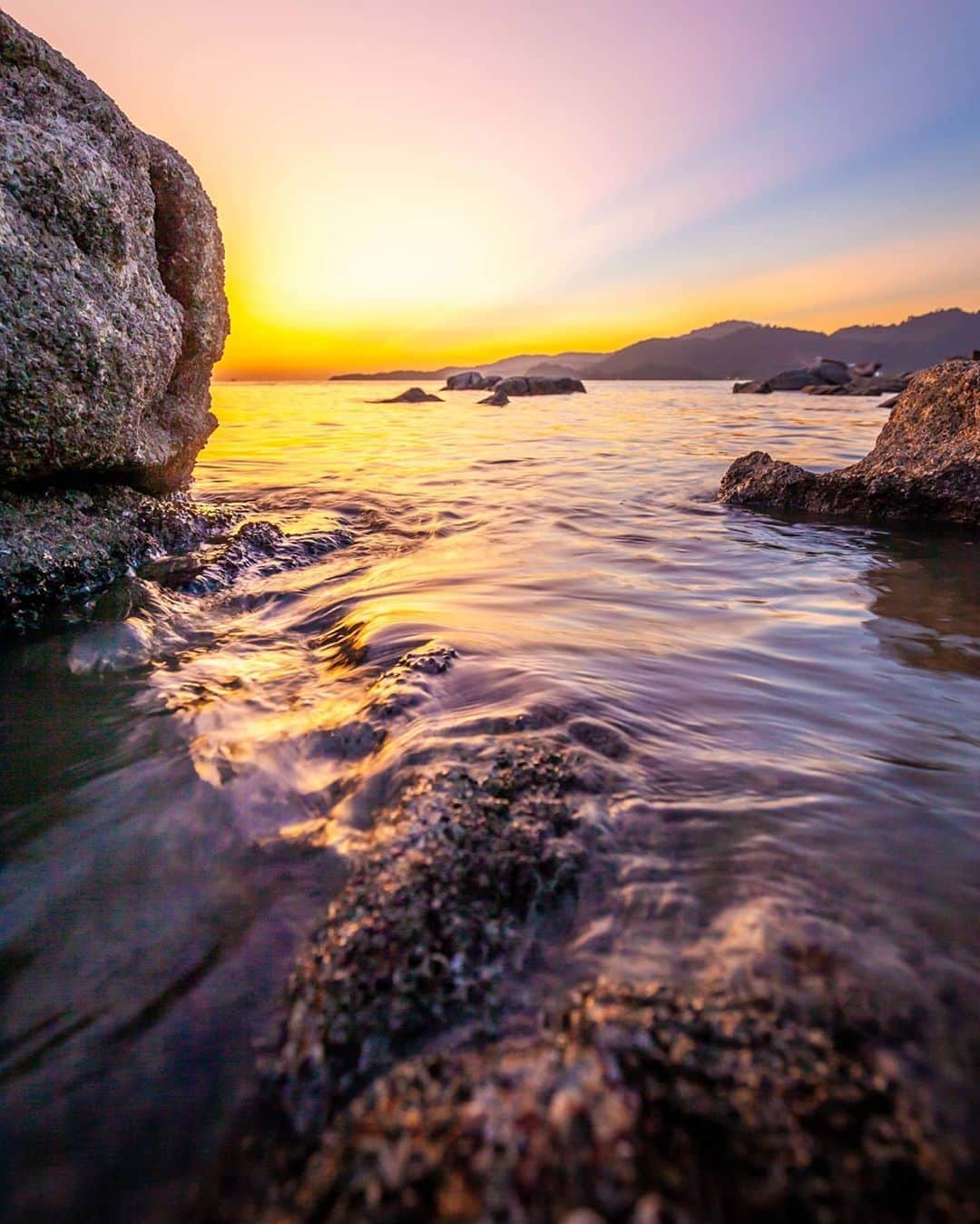Canon Asiaのインスタグラム：「If you're shooting with a larger aperture, always go about composing your shots with the foreground, middleground and background layers in mind.   @mercilessjun used the rock textures as the foreground to lead his viewer to the sunset scene in the background. . 📷 Image by @mercilessjun using the Canon EOS 5D Mark II • EF16-35mm f/4L IS USM • f/5 • ISO 400 • 1/10s • 16mm . Want your photos to be featured too? Tag them with #canonasia or submit them on My Canon Story, link in bio! . #canonasia #photography #explore #sunset #colours #canon #landscape #lens #inspiration #nature #sunset #sun」