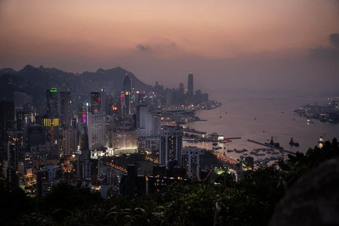 National Geographic Travelさんのインスタグラム写真 - (National Geographic TravelInstagram)「Photo by @mridulaamin  A purple sunset appears over Hong Kong’s skyline. It was well worth the questionable trek involving a bit of bouldering and fence-hopping when this scene came into view. Hong Kong holds the record for the most skyscrapers in the world. Much of the skyline’s architecture is influenced by the ancient Chinese practice of feng shui to encourage good luck. Developers can spend millions on consultants to organize where to place passageways and holes in the buildings to let energies flow in the optimal way. The Hong Kong government even pays out compensation to complainants who argue new developments disrupt their good feng shui.  For more photos from around the world, follow me @mridulaamin. #HongKong #FengShui」8月15日 21時07分 - natgeotravel