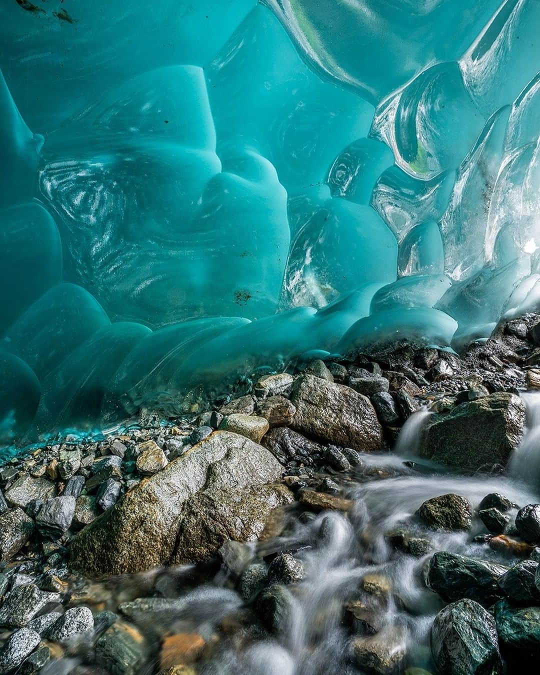 National Geographic Travelさんのインスタグラム写真 - (National Geographic TravelInstagram)「Photo by @stephen_matera  A small creek runs through an ice cave beneath the Mendenhall Glacier, Juneau Icefield, Alaska. As the Mendenhall Glacier retreats, it creates ice caves. The Mendenhall has retreated 1.75 miles (2.8 kilometers) since 1929 and continues to retreat. The ice is hundreds of years old at the terminus of the glacier and absorbs all wavelengths of light except blue, giving the glacier its incredible blue colors.  Follow me @stephen_matera for more images like this from Alaska and around the world. #glacier #icecave #juneauicefield」8月17日 1時06分 - natgeotravel