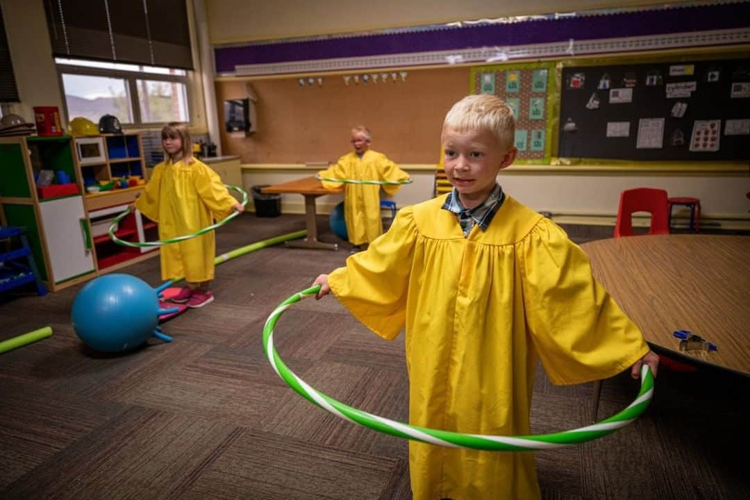 ナショナルジオグラフィックさんのインスタグラム写真 - (ナショナルジオグラフィックInstagram)「Photo by @amivitale  Dressed in his graduation gown, a kindergarten student holds a hula hoop. The class was using the hoops to encourage the students to stay an appropriate distance away from one another for their graduation ceremony. With just 16 days left in their school year, Willow Creek School in Willow Creek, Montana, was one of the first in the country to reopen to students. Because Willow Creek is a small, rural community with no reported cases of COVID-19 in the area, the school board felt comfortable allowing them to reinstate in-person instruction. Numerous safety protocols, temperature checks, social distancing measures and masks on faculty and staff were in place. Follow @amivitale for more stories from Montana during the pandemic.  @thephotosociety #schools #coronavirus #kindergarten #covid19 #graduation」7月24日 15時39分 - natgeo