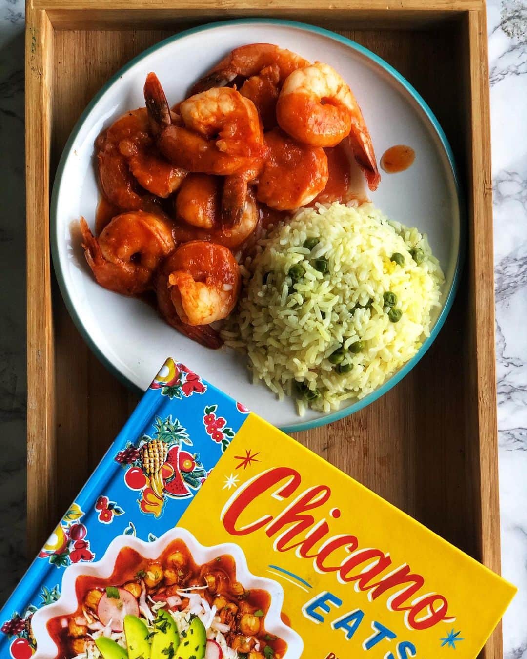 Antonietteのインスタグラム：「Really loving this cookbook from Esteban Castillo @chicanoeats. My kiddos picked this out for me as a birthday present and the cookbook has been a great guide for instilling recipes that we can use as traditional food in our relatively new multicultural family. We have  loved everything so far, and the food we have created from here helps the kiddos in remembering, appreciating and taking great pride in their heritage. 🇲🇽 Vibrant pictures, relatively simple prep and always a delicious outcome! Shown here are the camarones a la Diabla with arroz blanco with peas instead of corn. Buen provecho! 😋」