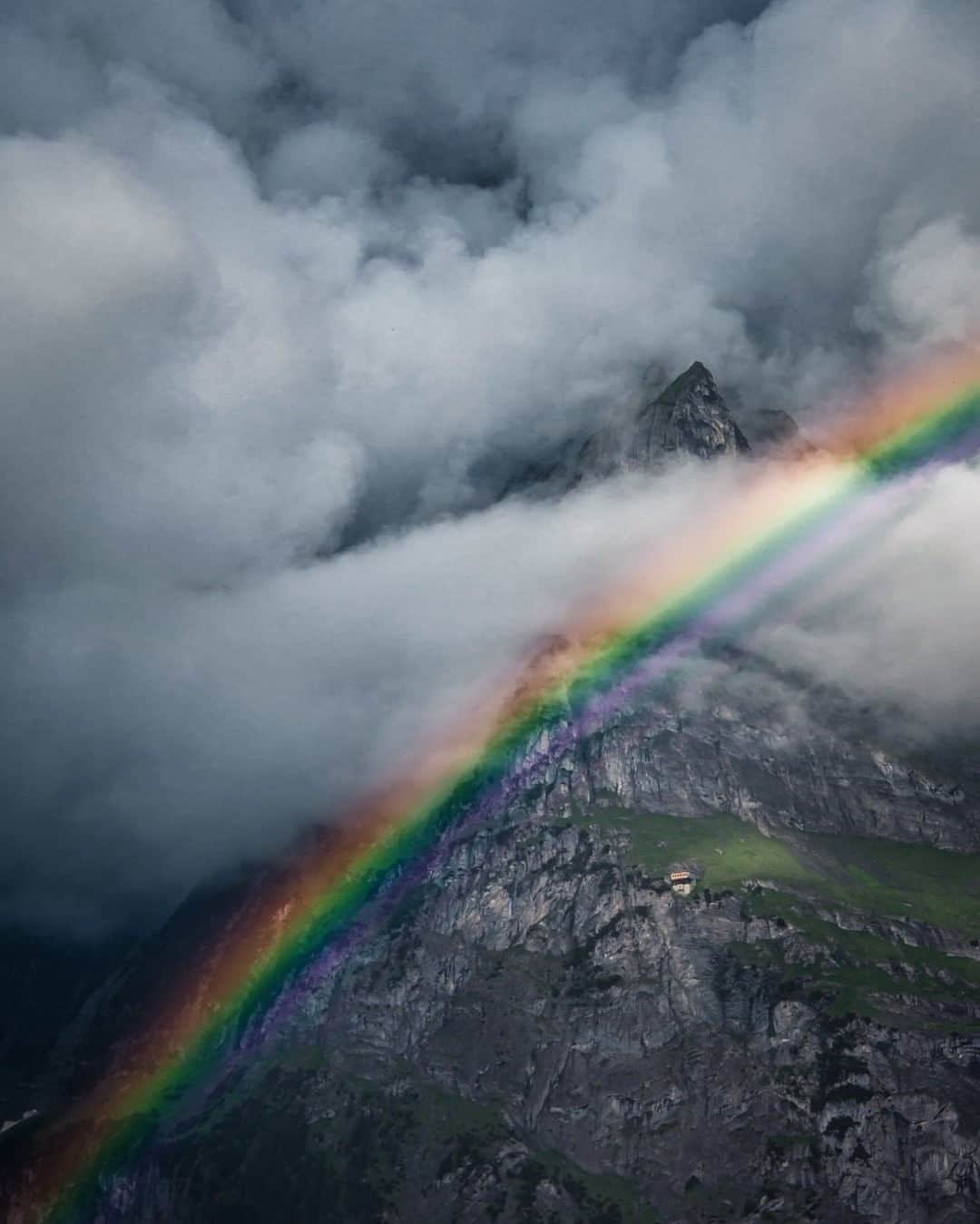 National Geographic Travelさんのインスタグラム写真 - (National Geographic TravelInstagram)「Photo by Keith Ladzinski @ladzinski  The Alps of Switzerland’s Grindelwald Valley are legendary for skiing, mountaineering, and sheer beauty. It’s a place where harsh weather can roll in without warning at any time. This vivid rainbow briefly appeared while a storm was breaking apart, lighting up the iconic valley for a few minutes before dissipating into thin air.」7月25日 9時05分 - natgeotravel