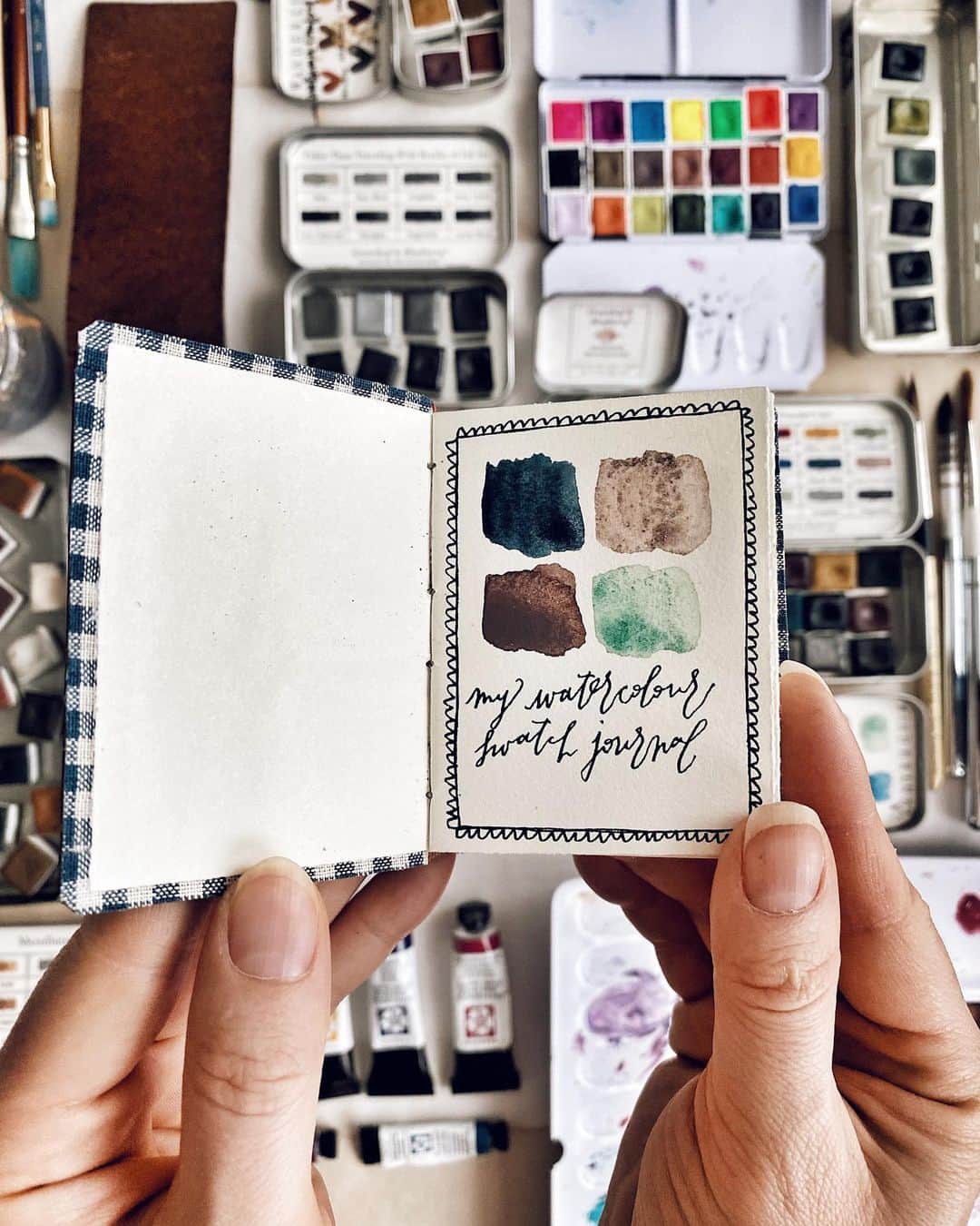Catharine Mi-Sookさんのインスタグラム写真 - (Catharine Mi-SookInstagram)「My hobbies will forever entail an array of color, creative musings, scribblings, books, folklore and the insatiability of imaginative musings and dreams. Today I’m organizing my watercolors and as you can see I adore the personality of palettes and tins that keep these troves safely tucked. I realized that my little handmade booklet from the @pegandawl IGTV Bookbinding Tutorials did not hold enough pages halfway in swatching my paints and suddenly a 💡 went off and I realized that the @pegandawl Mini Harper Journal would make a most wonderful companion to house and categorize a growing number of watercolor swatches. I also found the perfect use for their teeny tiny Miniature Sketchbook - a swatch booklet to fit inside a tin palette. And then the final crescendo upon discovering that a palette, the Harper journal, a beloved sketch pen and paint brush with room to spare could all neatly tuck in the Scribbler Pouch. It’s the little things. I have found that this swatch journal is a most peaceful way to wind down from a hectic day helping me slow my rhythms into a needed calm. I will be spending a good portion of my weekend down time happily filling these pages. And on that, happy Friday to all! I hope the weekend brings much rejuvenation and rest. . . . Today’s palette: Mini Harper Journal, Miniature Artist Sketchbook, Iris Painter Palette & Scribbler Pouch @pegandawl. Model 65 fountain pen @franklinchristoph (a rare sighting in a beautiful Emerald on the site). Waterproof DeAtrementis Document ink @justvanness. Handmade Watercolors @greenleafblue @wanderlustwc @caseformaking. Paints in my Iris Palette @danielsmithartistsmaterials. And one of my first artist grade sets @sennelier1887. . . . . #watercolorswatches #watercolours #watercolors #pegandawl #leatherjournal #leatherjournals #handmadebook #bookbinding #handmadejournal #franklinchristoph #fountainpens #sketchpen #flatlays #flatlaylove #handmadewatercolors #greenleafblueberry #caseformaking #wanderlustwc #sennelier #danielsmithwatercolors #artsupplies #handsinframe #creativespace #artjournals #watercolorpalette #watercolorpaint #stationeryaddict」7月25日 1時34分 - catharinemisook