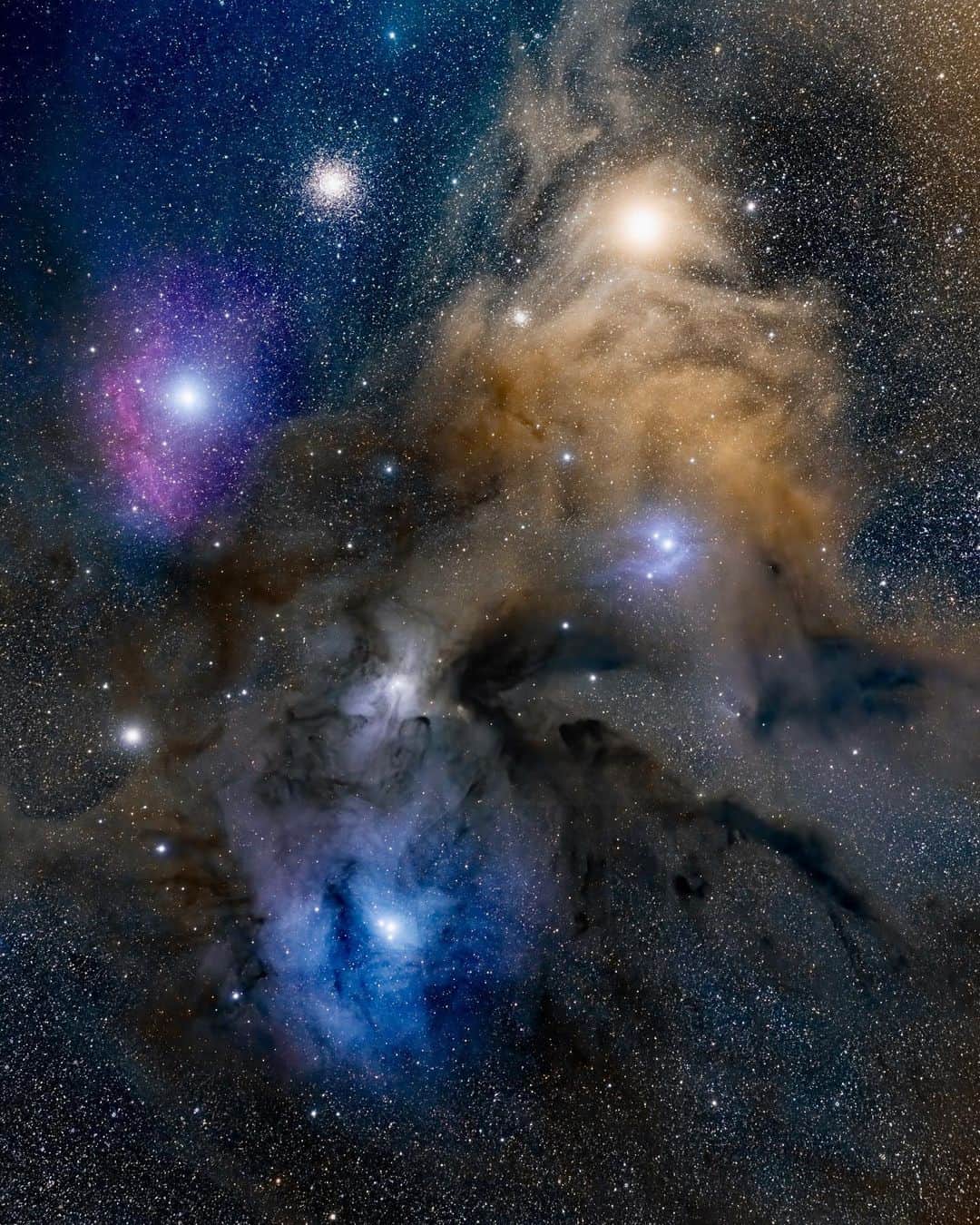 Travis Burkeのインスタグラム：「Exploring deeper into one of my favorite areas of the universe! ⠀ This is the ‘Rho Ophiuchi’ cloud complex. It’s a massive nebula of colorful cosmic dust and gas and is one of the closest place where new stars are born. If you swipe right, you can see a wide field view of where Rho is in the Milky Way galaxy.  ⠀ I’ve been fascinated by the dark arm that extends off of the Milky Way for as long as I can remember and I typically use it as a guide to judge my night sky images by how much definition I get in that area (because it’s only visible when there is very little light pollution).  ⠀ By combining the use of a telescope and the new @Fujifilmx_us medium format GFX 100 camera, which has a massive sensor that lets in more light in and has a higher dynamic range, I was able to capture more detail in the sky than I ever knew existed. ⠀ Huge thanks to Dustin (@gibsonpics) for continuing to help make these images possible and always encouraging me to look, and shoot, deeper into the universe!   #space #milkyway #opteam」