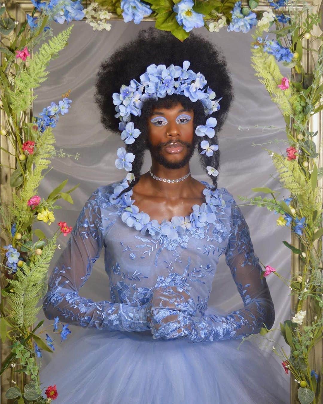 Paul Octaviousのインスタグラム：「If my fairy godmother doesn’t look like this I’ll turn myself into a pumpkin and roll down the lane!   These beautiful self portraits are by artist @chrissofly22.   If these photos were around when I was a young different  questioning the world, I would’ve known the future was going to be just fine.   boys can be princesses too✨☁️ . #queerartist #blackartists #queerart #diyphotoshoot #floridamodels #bluemakeup #blueflowers #floraldress #flowercrown #blackart #princess #dreamyaesthetic」