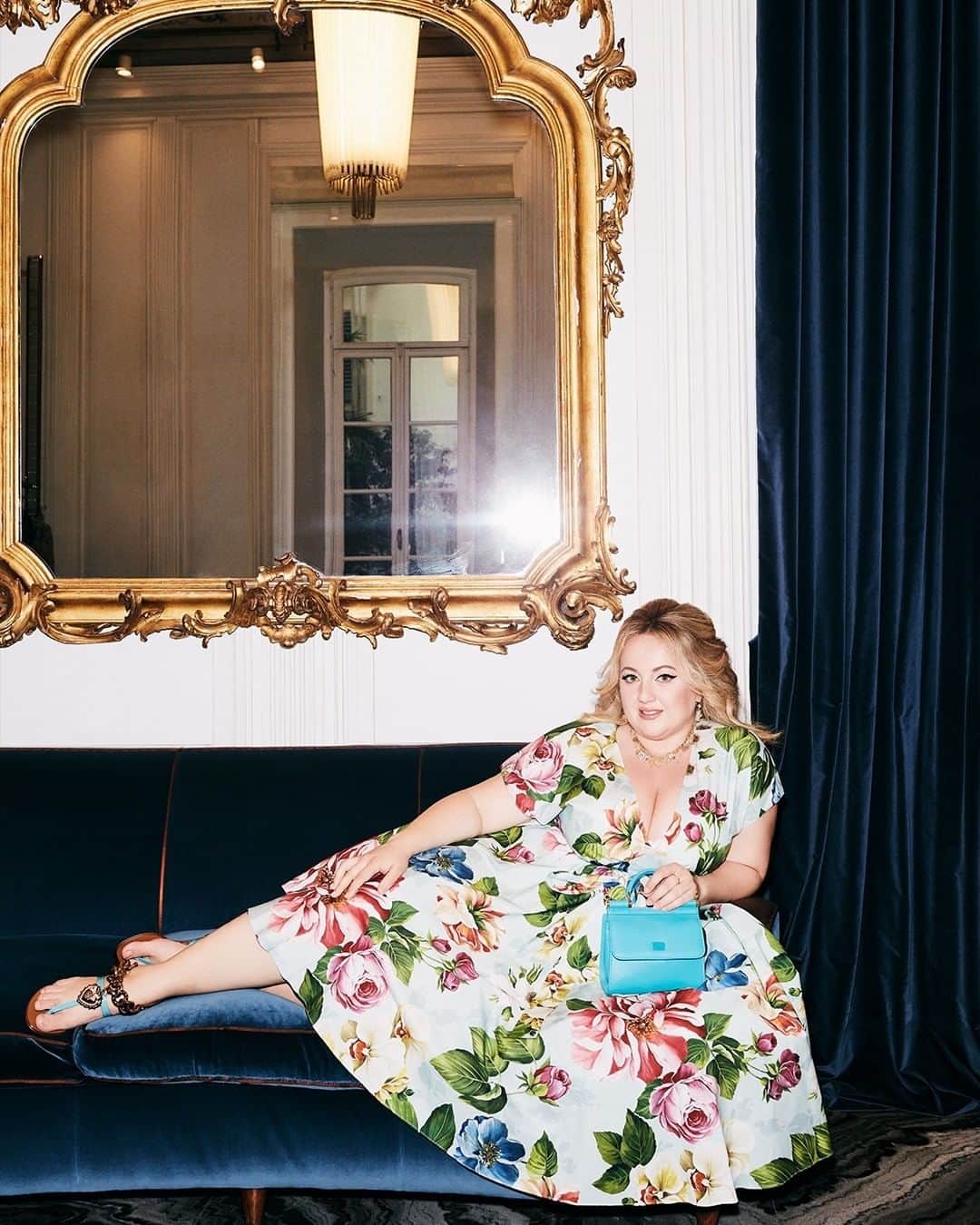 のインスタグラム：「@lady_violante is portrayed with a romantic floral-print midi length dress with cap sleeves and a belted waist.   The look is coupled with a light blue #DGSicily58 bag and a pair of sandals embellished with the iconic logoed bejeweled heart.  Discover the #DGWomen collection with sizes available up to an Italian 54.   #DolceGabbana #DGFamily」