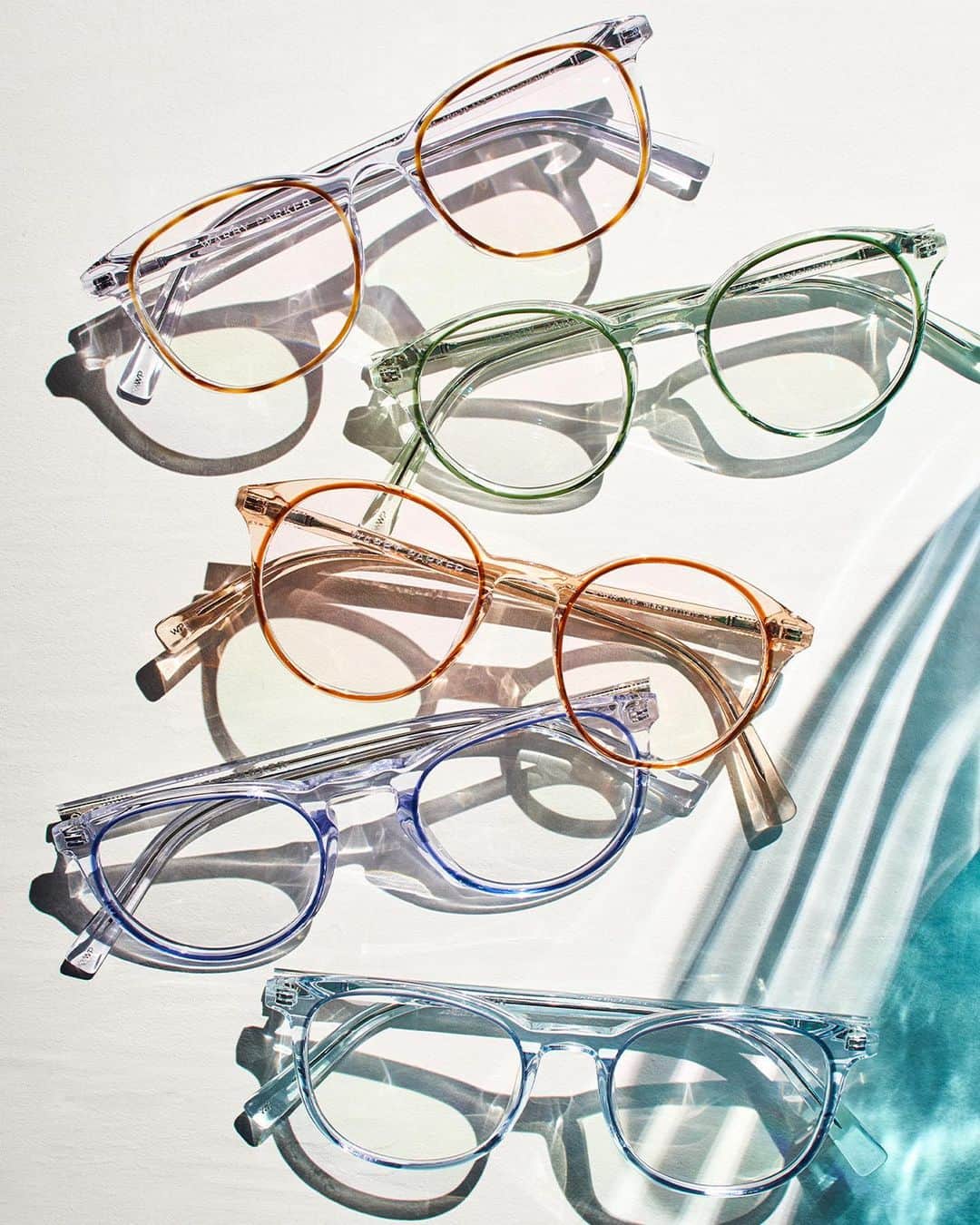Warby Parkerのインスタグラム：「Have you met the newest Concentric Collection? 🤤💫 Peep the latest riff on our signature construction featuring understated crystals with saturated lens rings. Many of these silhouettes now come in multiple widths to flatter every face! (Shown here from the 🔝: Durand in Crystal with Oak Barrel, Morgan in Traced Clover Crystal, Morgan in Traced Cedar Crystal, Haskell in Crystal with Blue Jay, and Durand in Traced Aquamarine Crystal)」