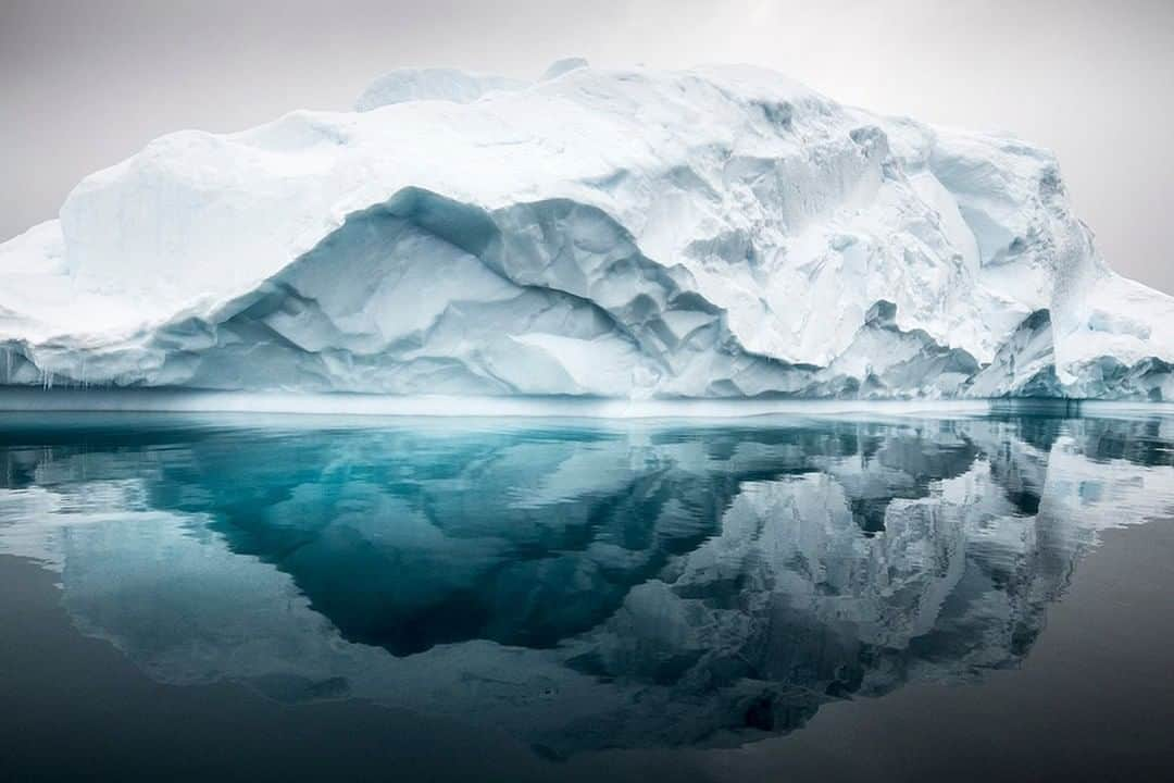 National Geographic Travelさんのインスタグラム写真 - (National Geographic TravelInstagram)「Photo by @daisygilardini  I’ve been blessed with many travels to Antarctica to see penguins, seals, birds, and whales. However, it all keeps coming back to being in love with the ice. As with an older person whose face has been carved by the wrinkles of time and wisdom, icebergs are carved over time by the weather. They instill in me the same kind of reverence and respect.  Follow me @DaisyGilardini for more images and stories behind the scenes. #antarctica #iceberg #ice #climatechange」7月31日 7時02分 - natgeotravel