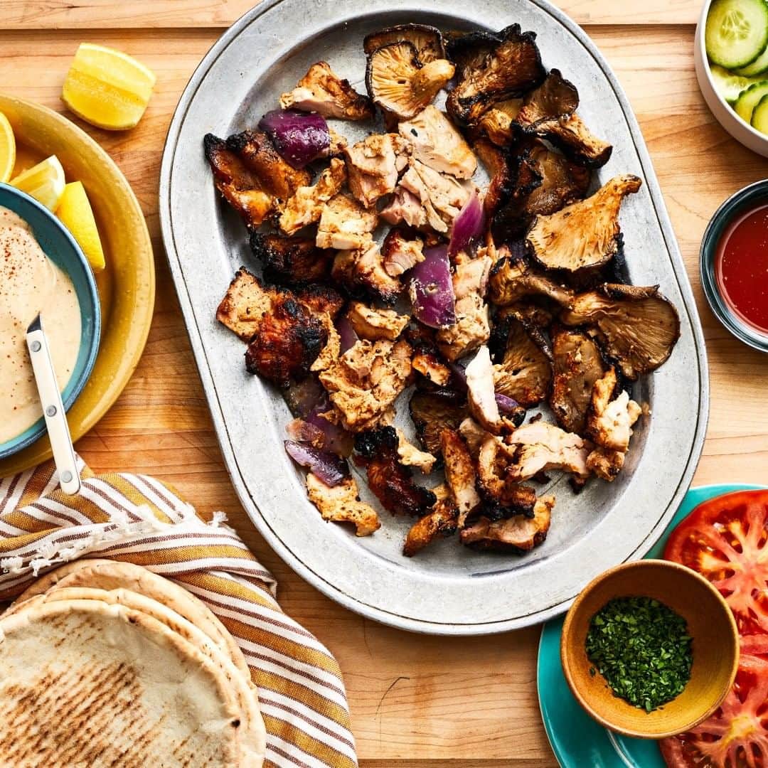Food & Wineさんのインスタグラム写真 - (Food & WineInstagram)「Senior Editor @maryfrancesheck's method for making shawarma at home involves triple-skewering thin slices of marinated chicken to create a tight horizontal roast—think of it as a sort of shawarma-kebab hybrid. Paired with grilled marinated mushrooms, fresh veggies, pita, and a creamy tahini sauce, the result is a gorgeous spread perfect for outdoor eating. Tap the link in our bio for her recipe. 📷: @protazio」8月4日 23時30分 - foodandwine