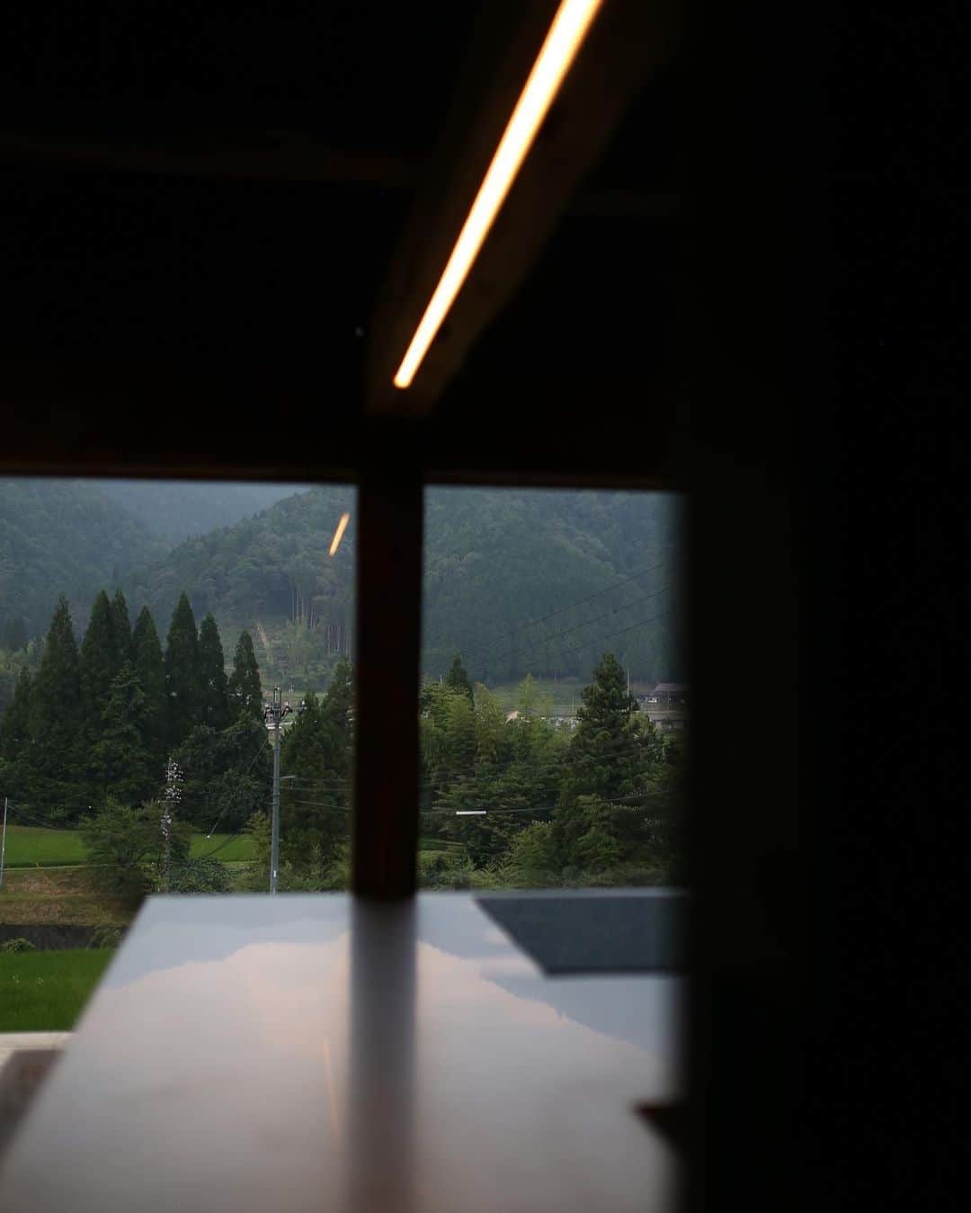 Tomohide Furuyaのインスタグラム：「" kawaue residence " . . 岐阜県・中津川の更に奥。 川上に出来た築170年の古民家を改装して生まれた滞在型宿泊古民家"kawaue residence" . . TAS WORKSとして照明計画でお手伝いさせていただきました。 . . 大きなカウンターの柱と梁は牛を繋いで置く為の馬小屋のもの。 . カウンターの上の梁に仕込ませた照明とガス灯をリメイクした照明が上手く効いてくれたかと思います。 . . その他にも、N.の新作のハーフブラストの照明や3RD CERAMICSに別注をしている銀彩ランプシェードなども提案させて頂きました。 . . モダンな雰囲気ももちろん、古き良き日本の原風景をテーマにした宿。 . . ぜひ皆さんチェックしてみて下さい。 . . 詳細は @discover.rural.japan より。プロフィールからHPもご覧頂けます。 . . . #kawaueresidence #tas_works #lightingdesign #照明計画 #古民家 #宿 #中津川」