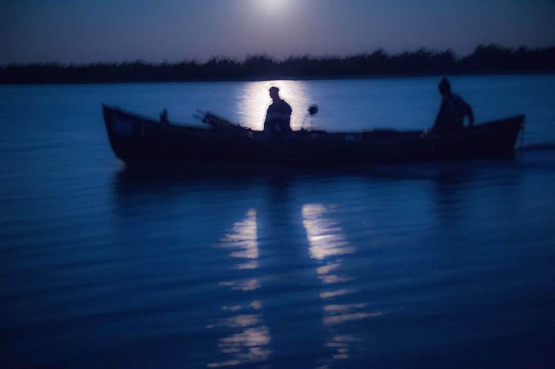 National Geographic Travelさんのインスタグラム写真 - (National Geographic TravelInstagram)「Photo by @amivitale  A fisherman works on the Danube River in the moonlight. I had the privilege of traveling the length of the Danube River as part of Danube Revisited: The Inge Morath Truck Project. Eight of us set out to follow Morath’s path along the Danube for five weeks. The photographers, each winners of Magnum’s Inge Morath Award, converted a truck into a mobile gallery space that we used to exhibit Morath’s work in the villages and towns she photographed. At the same time, we created a new body of work about contemporary life in the region, finishing groundbreaking photographer Morath's dream of following the Danube from start to finish.  A core motivation for all of us was to support the underrepresented female voice in documentary photography. We created a project that is for women, by women, and in the legacy of a pioneering woman. In line with this vision, Danube Revisited offered female photographers in the Danube region special exhibition and publishing opportunities as a part of the project.  Follow @amivitale for more stories about the beauty and hope in the world. @thephotosociety @photography.for.good #danube #ingemorath #rivers #water #reflections」8月6日 9時05分 - natgeotravel