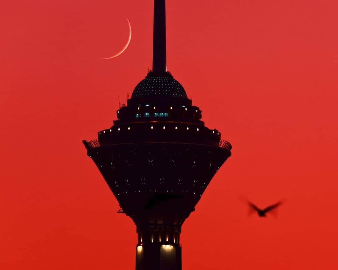 National Geographic Travelさんのインスタグラム写真 - (National Geographic TravelInstagram)「Photo by @babaktafreshi  The new moon appears during a red dusk in Tehran, the most populous city in West Asia with 15 million people in its metropolitan area. While the ancient Rey in the southern end of the city dates back to 6000 B.C., the elevated northern end reaching the Elburz Mountains is mainly modern constructions, including the 435-meter (1,427-foot) Milad Tower, which has a viewing platform to see Tehran if the air is not too polluted.  Follow me @babaktafreshi for more of the world’s landmarks at night. #twanight #tehran #newmoon」8月7日 19時04分 - natgeotravel