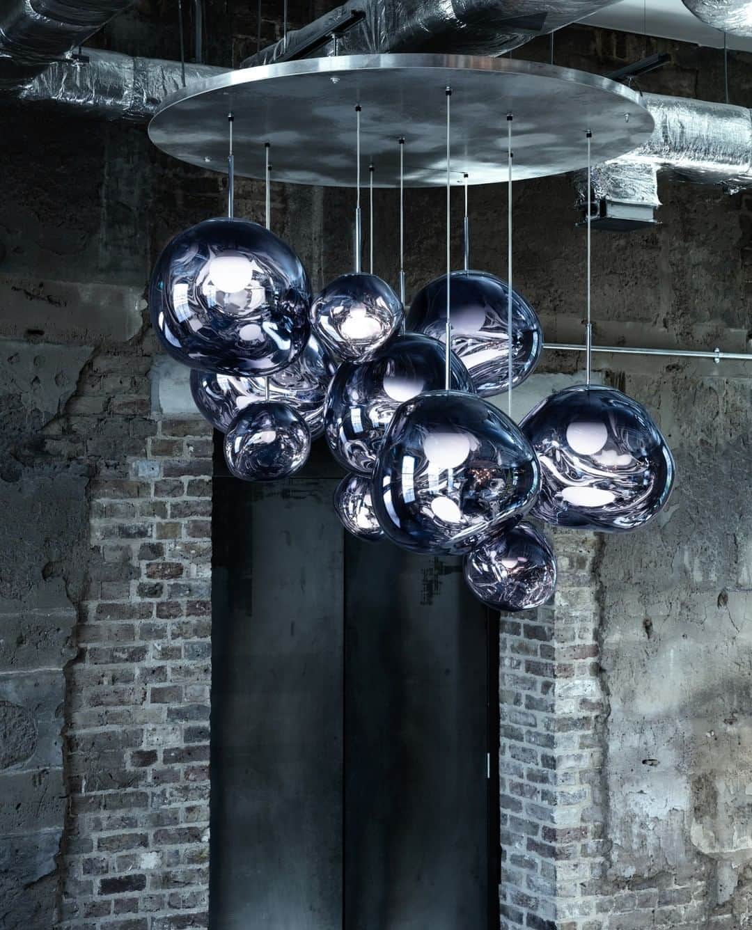 のインスタグラム：「A series of distorted spherical pendants, half-metallised to create an extraordinary optic effect and cast an ethereal luminosity on their surroundings.⁠」