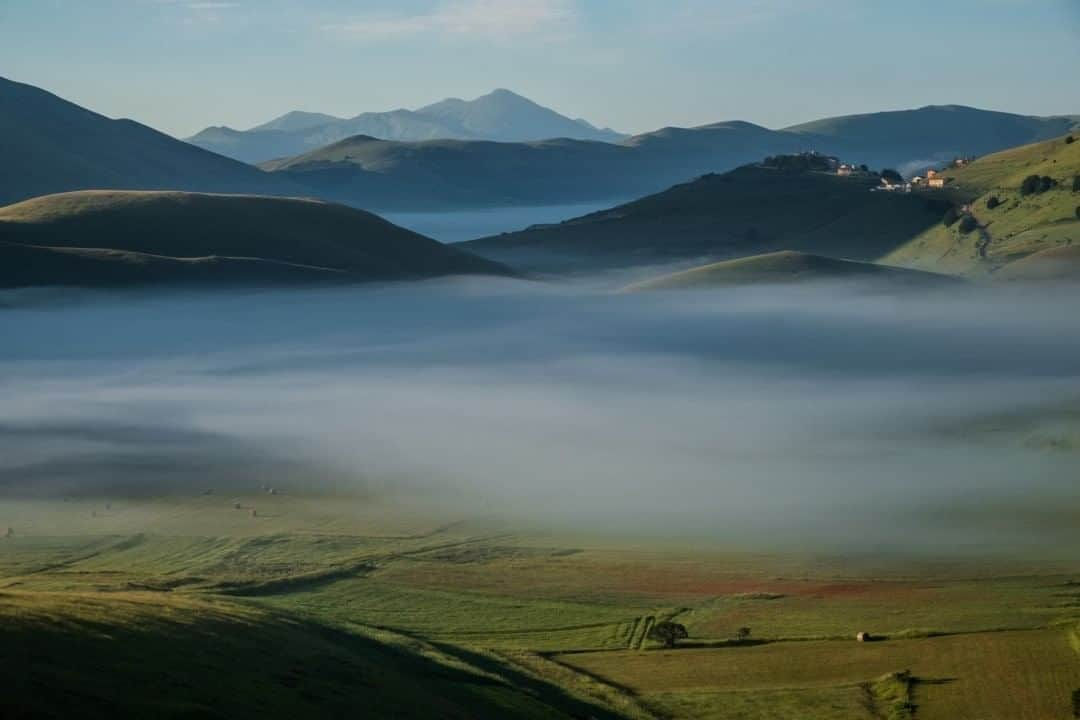 National Geographic Travelさんのインスタグラム写真 - (National Geographic TravelInstagram)「Photo by @francescolastrucci  A few weeks ago, driving along the winding mountain roads of the Apennines to Castelluccio di Norcia in the early hours of the morning, I cleared the last hill right after sunrise. The landscape that opened up before me was surprising: The plateau of Castelluccio di Norcia, in this remote part of Italy's Umbria region, was completely hidden by a thick mist. I didn’t have to wait too long for the early morning rays of the sun to slowly dissolve the mist, revealing fields of poppies and lentils in bloom, the gentle peaks of the Sibillini Mountains, and the medieval village of Castelluccio di Norcia. Part of a national park, the area was impacted by the 2016 earthquake, from which it is still recovering. It is partly sustained by tourism to Sibillini's wonderful sites and routes. Follow me @francescolastrucci for more places, daily life, and stories around the world. #italy #umbria #mountains」8月12日 9時04分 - natgeotravel