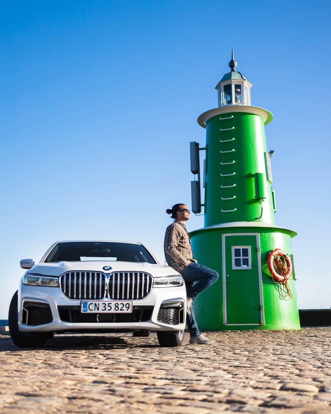 BMWのインスタグラム：「The lighthouse of success. The BMW 7 Series Sedan. #THE7 #BMW #7Series #BMWrepost @bmwdanmark @thetravelbook  __ BMW 745e Sedan: Energy consumption in kWh/100 km (combined): 15.5–15.1. Fuel consumption in l/100 km (combined): 2.2–2.1. CO2 emissions in g/km (combined): 51–48. Further information: www.bmw.com/disclaimer.  	 Acceleration (0-100 km/h): 5.2 s. Power: 290 kW, 394 hp, 600 Nm. Top speed (limited): 250 km/h.」