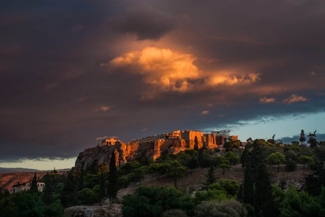 National Geographic Travelさんのインスタグラム写真 - (National Geographic TravelInstagram)「Photo by @francescolastrucci  A view of the Acropolis of Athens at sunset. As a storm was approaching the city center, I was rushing to walk down from Philopappou Hill when I noticed a sudden glimpse of golden light illuminating the dark clouds right above the Acropolis, adding a powerful note to the iconic mythology of the landmark.  Follow me @francescolastrucci for more places, daily life, and stories around the world. #athens #greece #landscape」9月9日 21時08分 - natgeotravel