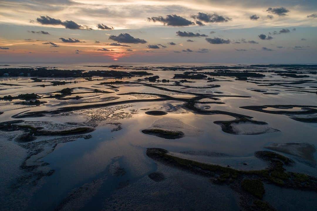 National Geographic Creativeさんのインスタグラム写真 - (National Geographic CreativeInstagram)「Photos by @carltonward  On assignment for @insidenatgeo making a Last Wild Places film about the importance of protecting the Florida Wildlife Corridor. We experienced some magical light as we followed clam farmers through their daily work in the nearshore Gulf of Mexico around Cedar Key, where the water quality of the estuary depends on conserving the wild and timber lands upstream on the Suwannee River. The first two photos show sister and brother Gretchen and Ian Stone (@gretchstone) on their morning commute to their clam lease before and during sunrise. The last photo, a drone shot, shows the oyster bars and barrier islands that structure the estuary around Cedar Key. The film our team captured during these late summer days is going to be powerful. Please follow @carltonward @pathofthepanther and @fl_wildcorridor as the story unfolds. #LastWildPlaces #KeepFLWild」9月10日 2時19分 - natgeointhefield
