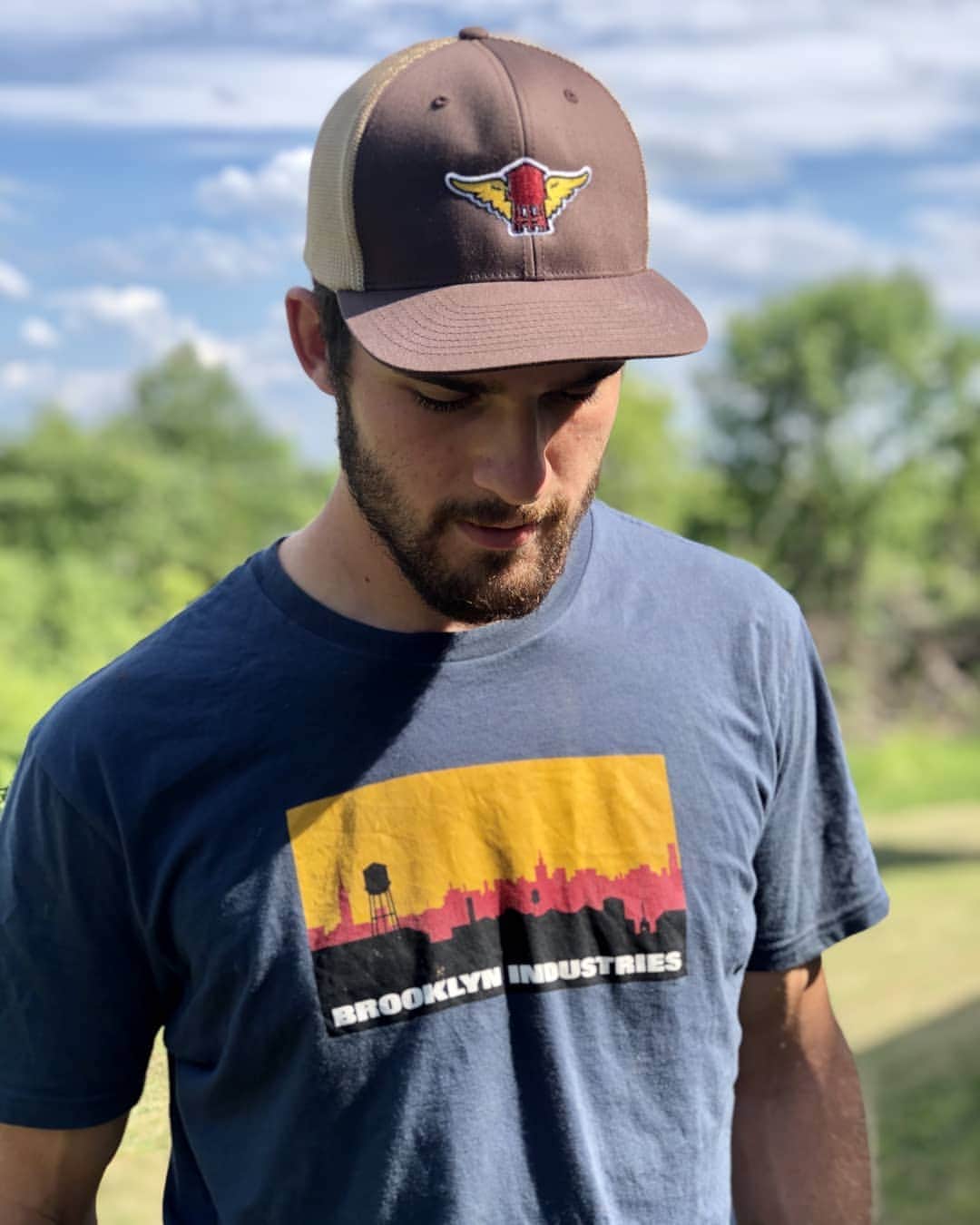 ブルックリンインダストリーズのインスタグラム：「Our Skyline Logo T-shirt never gets old.  Henry in Skyline Logo and the Water Tower Wing Trucker Cap.   #brooklynindustries #liveworkcreate #brooklynskyline #watertower」