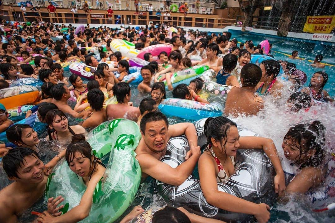 Michael Yamashitaさんのインスタグラム写真 - (Michael YamashitaInstagram)「Summerland, Tokyo, Japan: There's no question that given the heat, humidity and population of Tokyo in the summer, the throngs at any swimming pool there are going to, by definition, test the limits of crowd control and sanitation. Japan, however, is prepared for this and manages to keep everyone happy and cool no matter how jam-packed the pool – by moving the water rather than the swimmers. While not exactly conducive to laps, giant wave pools surge with swells a meter or higher, drenching stationary bathers so they don't need to swim to cool off. Other pools feature circular courses with a current that keeps everyone moving together in the same, very orderly, direction. And of course, Japanese people, by tradition and habit, are arguably the cleanest – not to mention the most cleanliness-conscious – in the world. The water in these pools is clean enough to drink! These photographs were taken several years ago. Though closed at the onset of the Covid-19 pandemic, the water park re-opened on July 13, with limited reserved admission, health checks, social distancing and mandatory masks for patrons and staff, as well as detailed instructions in coughing etiquette. #summerland #tokyosummer #summertime #tokyosummerland #worldphotographyday」8月19日 23時58分 - yamashitaphoto