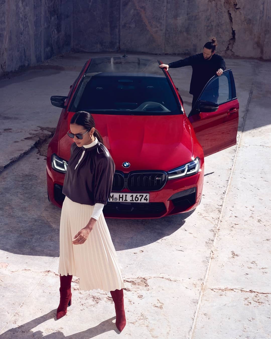 BMWのインスタグラム：「Long skirt, short nights, red boots, fun drives. Summer, you have been unusual!  The new BMW M5 Competition. __ BMW M5 Competition Sedan: Fuel consumption in l/100 km (combined): 10.6–10.5. CO2 emissions in g/km (combined): 242–239. Further information: www.bmw.com/disclaimer. Acceleration (0-100 km/h): 3.3 s. Power: 460 kW, 625 hp, 750 Nm. Top speed (limited): 250 km/h (with optional M Drivers Package: 305 km/h).」