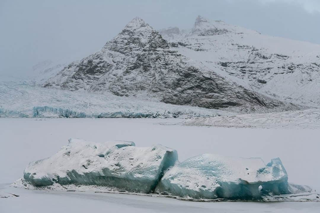 National Geographic Travelさんのインスタグラム写真 - (National Geographic TravelInstagram)「Photo by Matt Borowick @mborowick  An iceberg frozen in the Fjallsarlon glacier lagoon is seen with the peak of Miðaftanstindur rising in the background in eastern Iceland. Right before the pandemic took its hold on the world, I was able to travel to this beautiful frozen island and explore what the winter had to offer. Follow @mborowick for more pictures like this. #glacier #wild #adventure #iceland #mountains」8月20日 19時03分 - natgeotravel