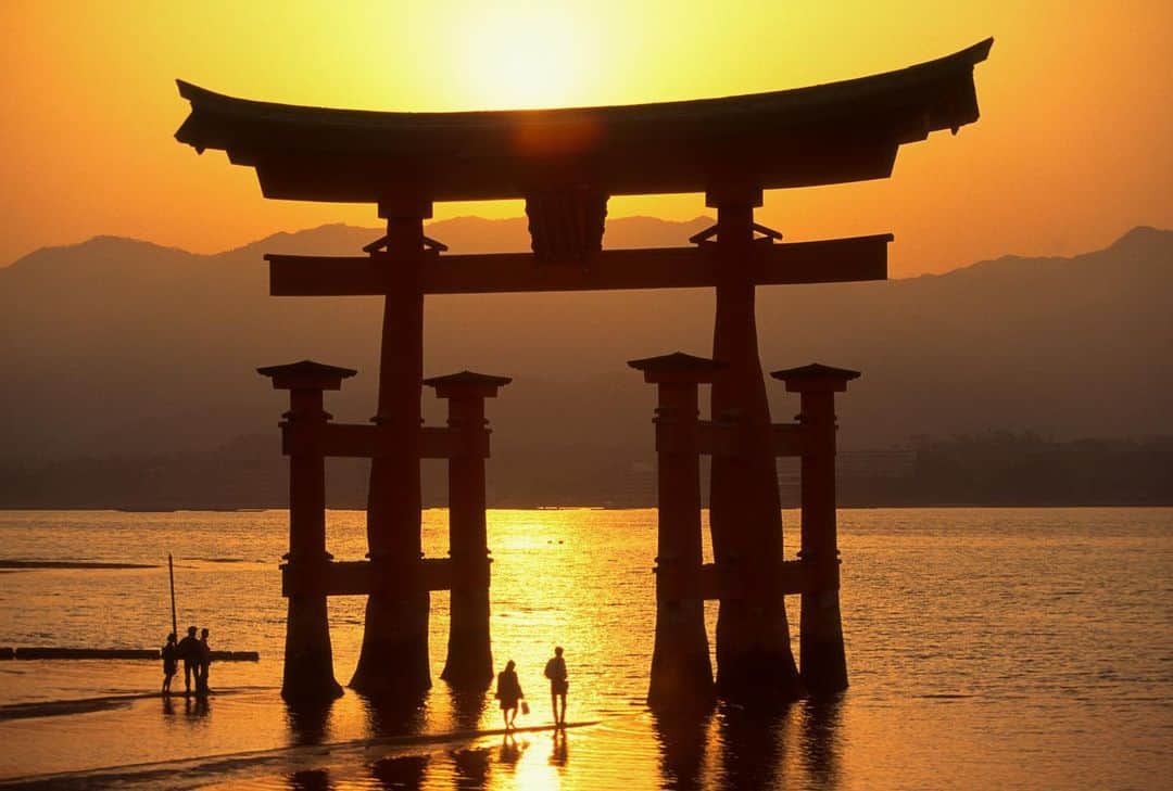 Michael Yamashitaさんのインスタグラム写真 - (Michael YamashitaInstagram)「Itsukushima Shrine is one of the most significant Shinto shrines in Japan and the only shrine in the world seemingly built on top of water. The name 'Itsukushima' literally means 'island of worship', and from ancient times the island itself was worshipped as a god. From its beginnings, the Itsukushima Shrine drew fishermen and tradesmen who sailed the Seto Inland Sea. Visitors today still pray for the safety of those who ply the sea.    The view of Itsukushima Shrine and its distinctive red O-torii gate, meant to be a portal between the mundane and the sacred, has long been considered one of the three finest in Japan. It is a designated Japanese National Treasure and was inscribed as a World Heritage Site in 1996. At high tide, both the O-Torii gate and the shrine appear to float on top of the water. At low tide, visitors can walk right up to the foot of the gate to experience it up close and see the three 'mirror ponds' that often appear in the exposed sand around the shrine. #itsukushima #itsukushimashrine #hiroshimajapan #shrine #japaneseshrine  #hiroshima」8月23日 8時12分 - yamashitaphoto