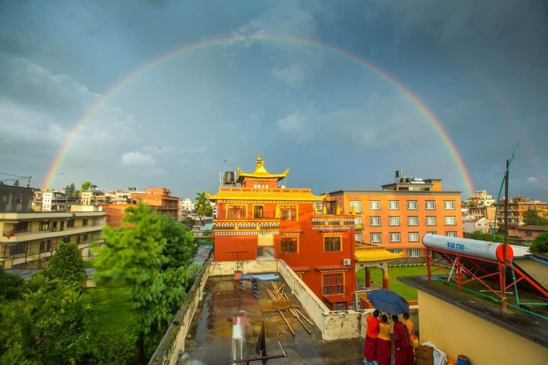 National Geographic Travelさんのインスタグラム写真 - (National Geographic TravelInstagram)「Photo by @emilypolar  A full rainbow appears over my neighboring monastery during a monsoon in Boudha, Nepal. At the same time, another full rainbow appeared over their sister monastery in Tibet. The monks next door excitedly showed me photos of the rainbow in Tibet and informed me that one of their venerable teachers had just passed away. The appearance of rainbows after the passing of an accomplished practitioner is a very auspicious sign.  To see more of the magnificence in the mundane in Nepal and beyond, follow me @emilypolar. #Nepal #Boudha #Rainbow」8月25日 7時02分 - natgeotravel