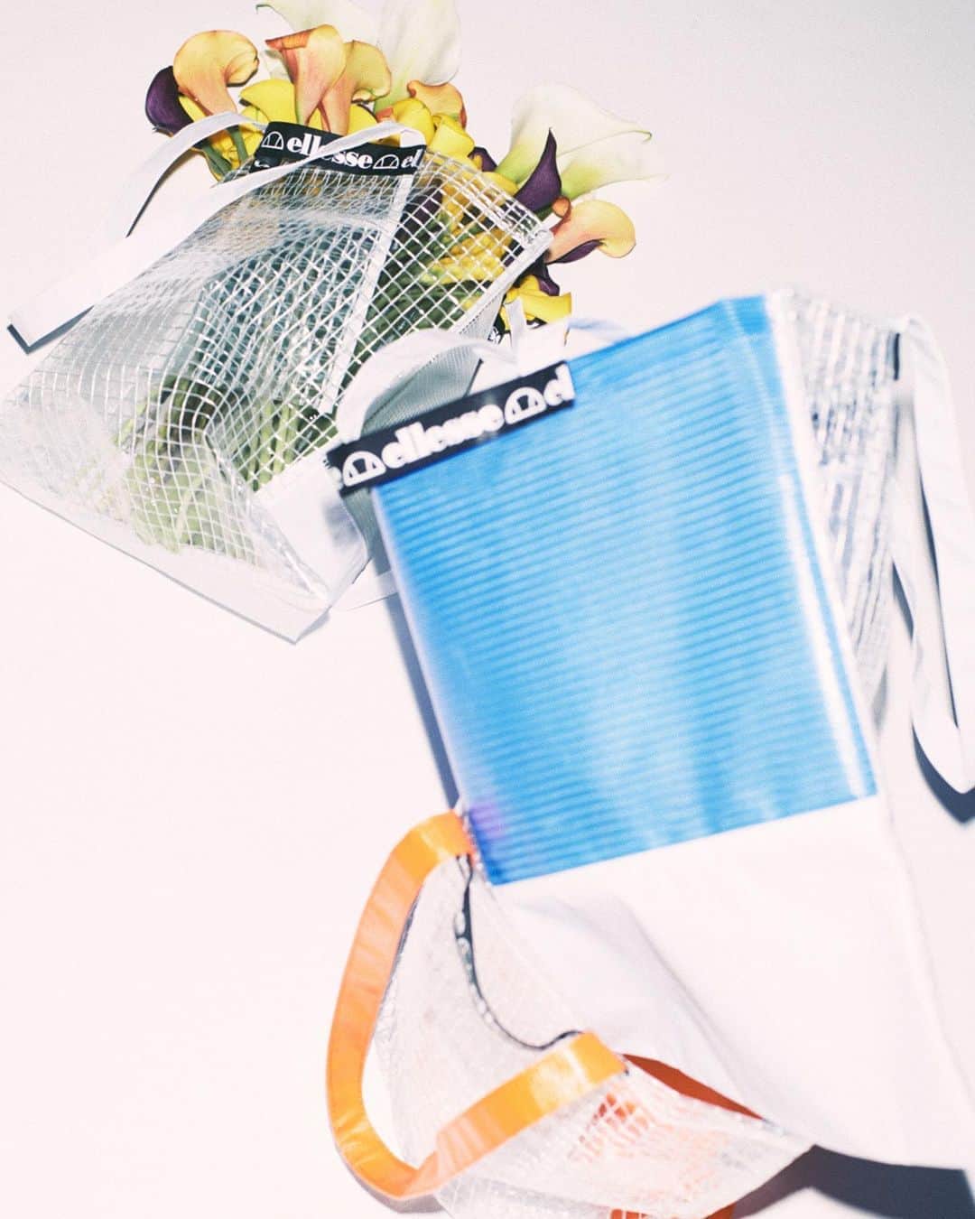 のインスタグラム：「Items｜*Colorful Tote* 異素材のビニール素材を切り替えたトートバッグ。中身がうっすら透ける仕様で夏らしいデザインが特徴。 ... Colorful Tote [EHA60325] ¥3,850 ... #ellesse #エレッセ」