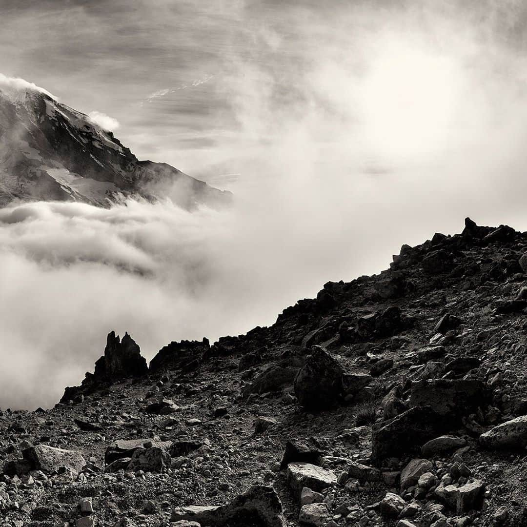 National Geographic Travelさんのインスタグラム写真 - (National Geographic TravelInstagram)「Photo by @stephen_matera  Mount Rainier appears through swirling low and high clouds in summer. At over 14,000 feet (4,267 meters), the vertical rise is large enough that Mount Rainier creates its own weather, as seen here when clouds form around the mountain on an otherwise clear day. Follow me @stephen_matera for more images like this from Mount Rainier National Park and around the world. #volcano #nationalpark #lenticularcloud」8月29日 1時07分 - natgeotravel