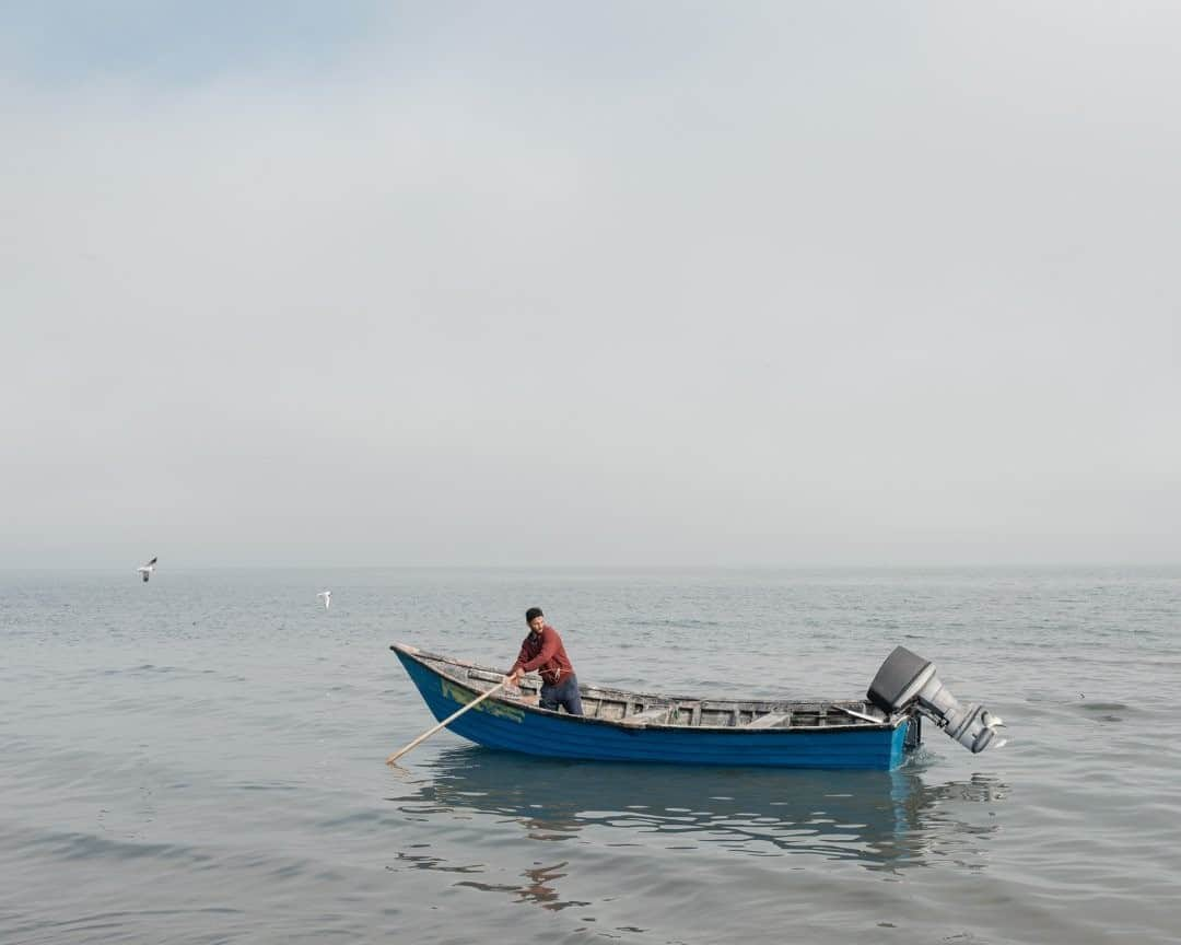 National Geographic Travelさんのインスタグラム写真 - (National Geographic TravelInstagram)「Photo by Muhammad Fadli @mfimages  A fisherman works in Bandar-e Anzali, a city by the Caspian Sea in Gilan Province, Iran. The city is a center of caviar production and home to the biggest port on the southern shores of the Caspian Sea. Visiting the city before my overland crossing to Azerbaijan was a real delight. Follow @mfimages for more images and stories. #caspiansea #bandaranzali #iran」8月29日 17時08分 - natgeotravel