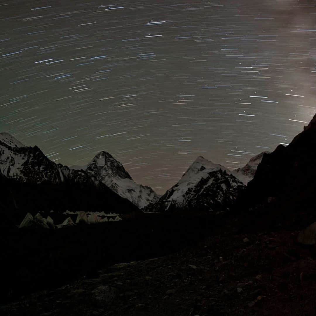 thephotosocietyさんのインスタグラム写真 - (thephotosocietyInstagram)「Photo by @tommy.heinrich / Words by @chipbrownnyc  A tiny pinprick of light emanates from the tent of the successful summit team (on the peak at center left) signaling their return to the bivouac site at 8,300 meters after 15 hours of climbing.  On assignment @natgeo and as a team member of the expedition led by Ralf Dujmovits, on August 23rd 2011 Gerlinde Kaltenbrunner, Maxut Zhumayev and Vassily Pivtstov reached the summit of K2 and completed the ascent of all 8000 meter mountains without oxygen, together with Darek Zaluski who stood on his 5th 8000er. Hours before making this picture, eager to reach the top, focused on photographing, climbing with a heavy load, I realized there was no room for error when swept and buried under the avalanches. Perhaps one of the hardest decisions I faced was to turn back during our final summit push. While on assignment @natgeo I felt committed to return with great images rather than reaching the top. This 14 minute exposure was made from Advanced Base Camp, more than two miles away. And I still wish I had been with my teammates on the summit that day, I still wish I was part of that light glowing with the stars….  But I would Not have captured this moment that sums why we climb.   We were one…. as a team….   We were one…. with the mountain.    @natgeo  @thephotosociety  @nikonargentinaoficial  #xinjiang #k2northface  #k2 #mountaineering  #expeditions  #climbing  #motivation  #inspiration  #teamwork  #conferencias  #motivacion  #inspiracion」8月29日 11時56分 - thephotosociety