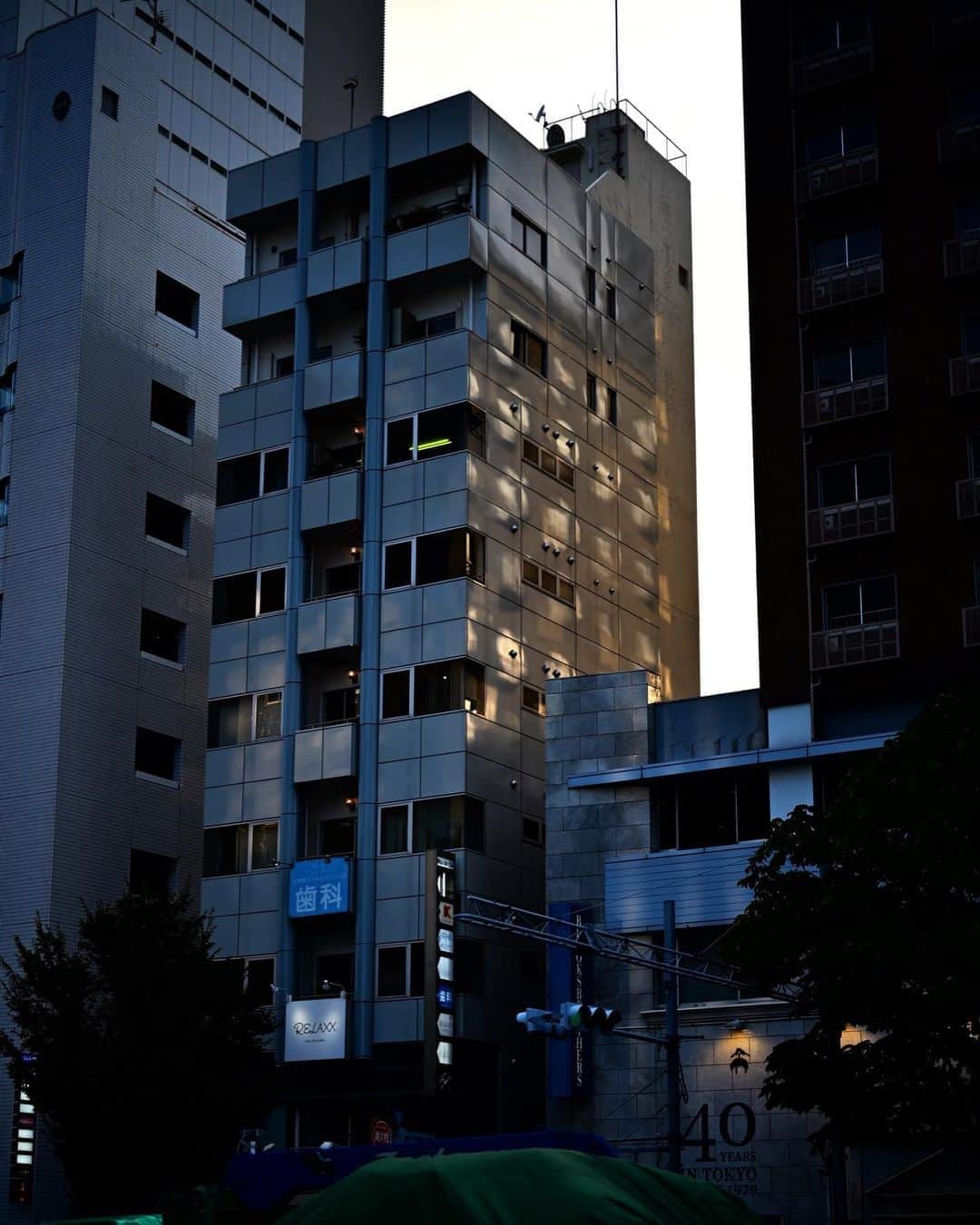 佐藤東弥のインスタグラム：「ビルの壁面に、隣のビルの窓ガラスにあたった夕陽が反射していた 木漏れ日みたいだった」