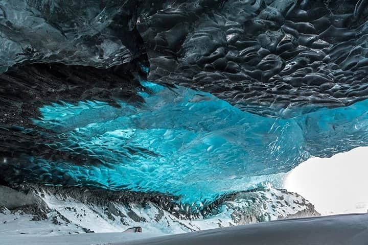 National Geographic Travelさんのインスタグラム写真 - (National Geographic TravelInstagram)「Photo by @daisygilardini / I visited this wonderful cave in Svalbard in early spring, when temperatures were still well below freezing. Glacier caves are ice caves that form under the ice of a glacier. They often originate as rivers that flow under the glacier during the summer months, when the glacier’s surface ice melt is at its maximum. It is never recommended to visit glacial caves during summer for this very reason. The combination of ice melt and glacial motion can be unpredictable and dangerous. #icecave #glaciercave #svalbard #ice #climatechange」10月4日 5時06分 - natgeotravel