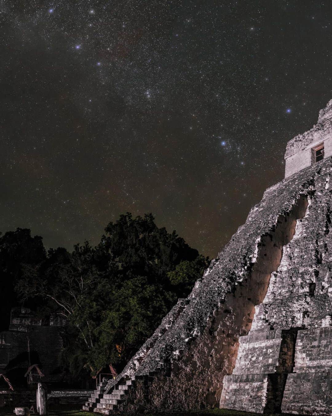 National Geographic Travelさんのインスタグラム写真 - (National Geographic TravelInstagram)「Photo by @BabakTafreshi  Slowly swipe to see the entire night view of this impressive Maya temple in Tikal known as the Great Jaguar. In fact, you may hear the big cat if you spend enough time in this jungle at night. Protected in a national park in Guatemala, jaguars freely roam around the temples after dark, when tourists have departed.  When I visited last year with special permission from the Guatemala Ministry of Culture to document the site at night, the tropical sky had cleared after thunderstorms. As you see in the second slide, constellation Taurus (the Bull) and the Pleiades star cluster (also known as the Seven Sisters) were rising above the 47-meter (154-foot) pyramid, which dates to A.D. 750.  There are both old stories and new studies on the importance of the Pleiades to the Maya. One myth is that the people of Tikal believed they came from Pleiades, and the seven important pyramids of the Grand Plaza in Tikal represent the pattern of Pleiades. There is no doubt that some Maya pyramids were built to reflect astronomical events, and from atop Tikal’s pyramids, perhaps ancient astronomers tracked the movements of celestial objects, keeping time for rituals and agriculture. The Maya calendar was one of the most advanced of the ancient world, thanks to astronomical observations. When Pleiades rises at sunset and is visible for the entire night in November, that’s when the dry season and harvesting begin.  Explore more of the world at night @babaktafreshi and @twanight. #tikalnationalpark #guatemala #maya」9月12日 1時16分 - natgeotravel
