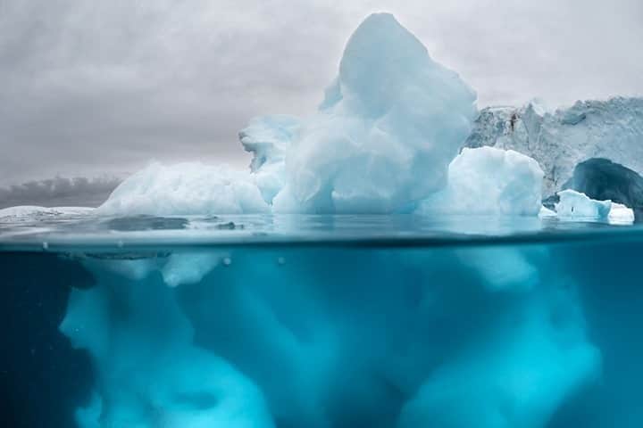 National Geographic Travelさんのインスタグラム写真 - (National Geographic TravelInstagram)「Photo by @DaisyGilardini  During my recent trip to Antarctica, I focused on photographing icebergs. Most of us know that as much as 90 percent of an iceberg lies below the waterline. I use my underwater case to try to capture both worlds above and below the blue line. Split shots are not easy to achieve in cold water. Most of the time you shoot blind, holding your gear over the side of a Zodiac. Usually you end up shooting hundreds of images and get only a few that are fine. Follow me @DaisyGilardini for more images and stories behind the scenes. #Antarctica #ice #iceberg #conservation #climatechange」9月13日 5時06分 - natgeotravel