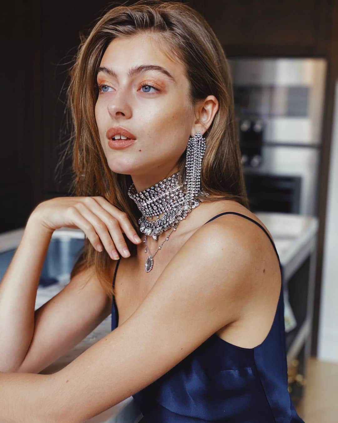 ダニジョーのインスタグラム：「Hasn’t left home in weeks, but still gets dressed up 💅 @lonepn in the slip, waterfall earrings and neckparty 〰️ Tap to shop #dannijoathome」