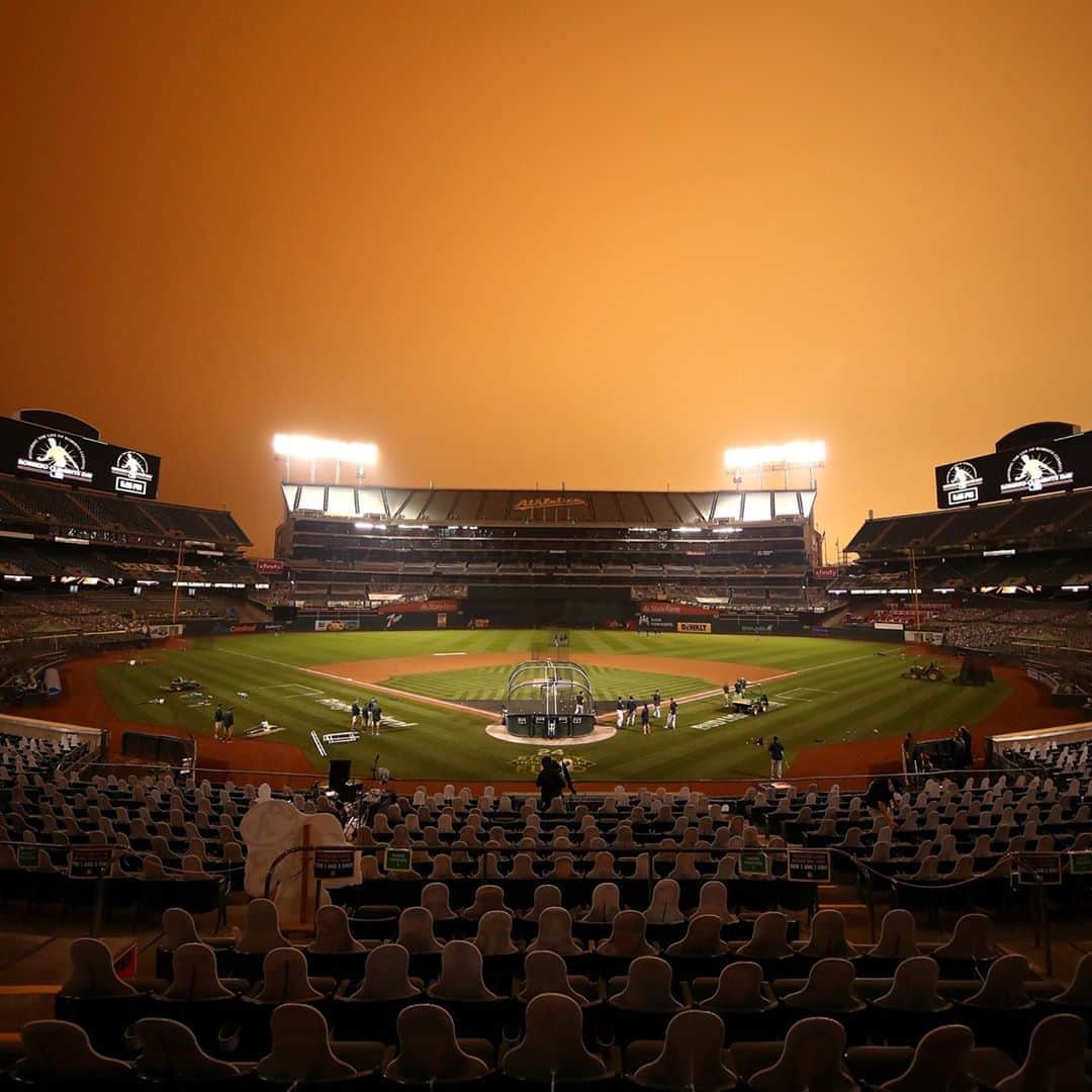 TIME Magazineさんのインスタグラム写真 - (TIME MagazineInstagram)「The Houston Astros take batting practice before their game against the Oakland Athletics at RingCentral Coliseum in Oakland, Calif., on Sept. 9. Smoke from regional wildfires led to an eerie orange haze over the area; inside the stadium, some stands are filled with cutouts of fans due to pandemic-related crowd restrictions. Photograph by Ezra Shaw (@eoshaw)—@gettyimages」9月14日 4時03分 - time