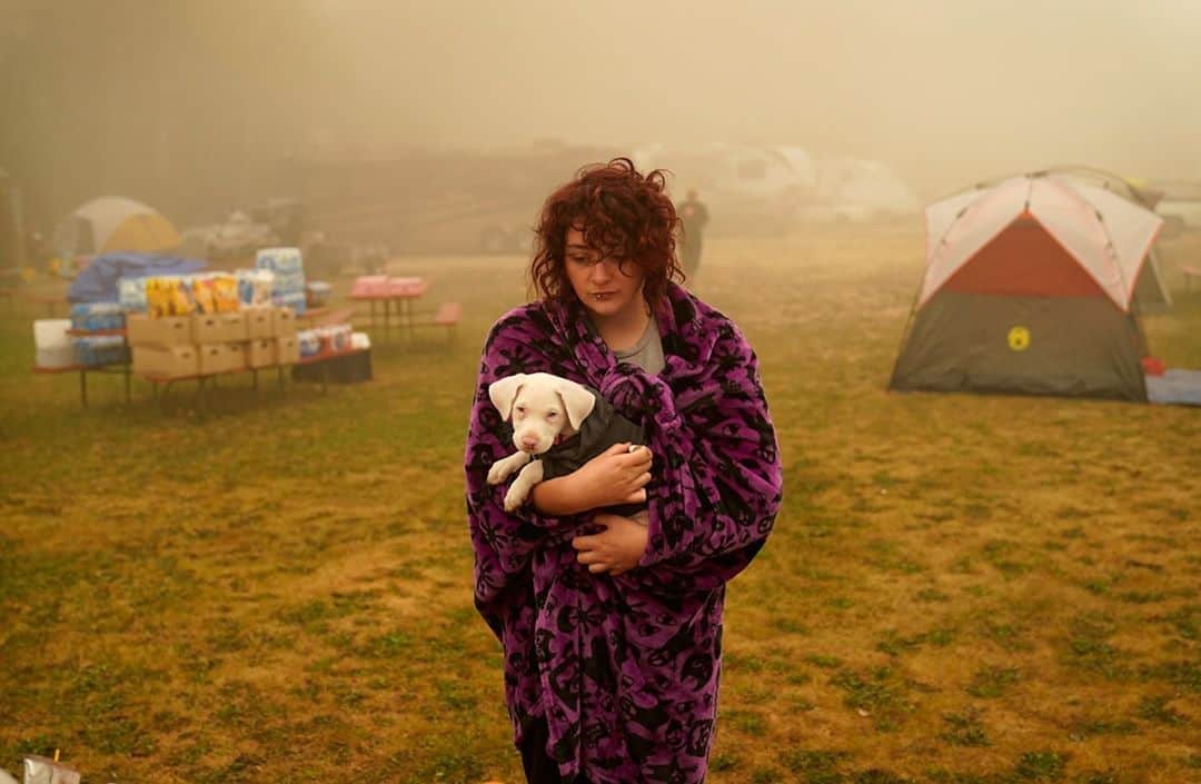TIME Magazineさんのインスタグラム写真 - (TIME MagazineInstagram)「Shayanne Summers holds her dog, Toph, while wrapped in a blanket after several days of staying in a tent at an evacuation center at the Milwaukie-Portland Elks Lodge in Oak Grove, Ore., on Sept. 13. "It's nice enough here you could almost think of this as camping and forget everything else—almost," Summers said about staying at the center after evacuating from near Molalla, which was threatened by the Riverside Fire. As of Sunday morning, the blaze had burned more than 133,000 acres and remained 0% contained. Photograph by John Locher (@locherphoto)—@apnews」9月14日 10時40分 - time